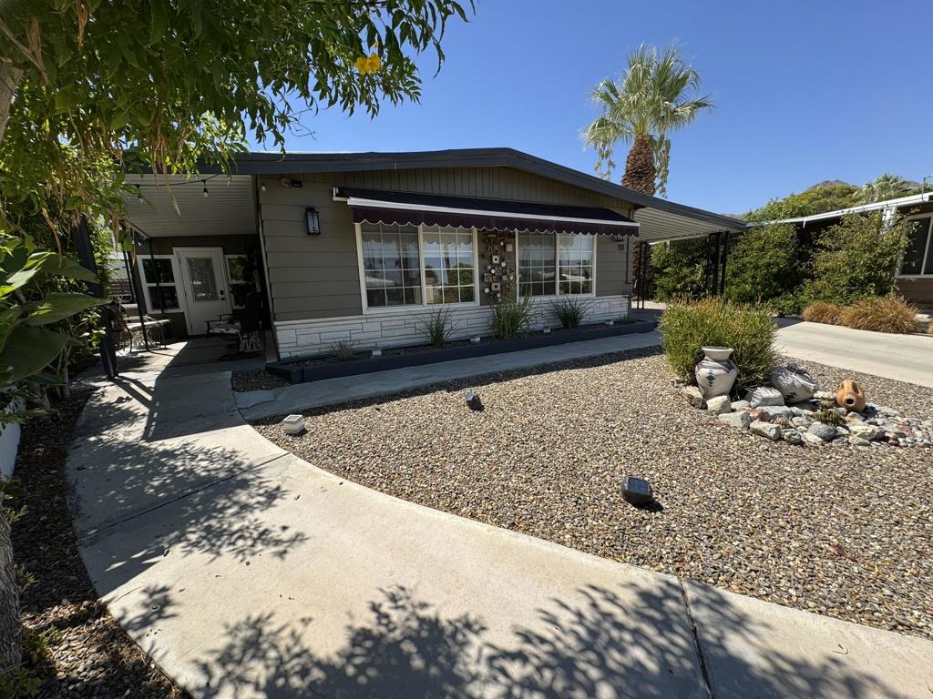 Incredible remodel with a fabulous yard!!!! Beautifully remodeled from top to bottom! Move-in Ready and Furnished!!! Interior boasts a new Chefs kitchen w/ rich Charcoal Cabinetry, Granite Counters, SS LG Appliances, Island w/ Gas Cooktop plus storage & Seating. Microwave/Convection Wall Oven. Custom designed wall to ceiling LED lighted Hutch. High-end, custom made Interior Doors & Barn Doors. All new Bathrooms offer walk-in tiled showers with glass sliders plus built-in cabinets. The home opens up to an Air Conditioned, fully enclosed California Room (included in the square footage) with new tinted windows, doors, floors & accent wall. New 4 Ton AC & Furnace, 2 New Fujitsu AC Splits, New Luxury Vinyl Floors & Double Pane Windows throughout. Recessed lighting. New roofing. Tons of storage offered with 3 exterior storage units. One of the units is a large 12x12 'Casita' styled building w/ floors, windows, wall AC, sliding glass door and electricity! You can ''downsize'' without sacrificing a thing in this home!!! Comes Furnished with 4 wall-hung Televisions. (one is outside) Kitchen table & chairs, 4 barstools, Dining Table & Chairs, Dual reclining leather sofa, reclining leather chair, buffet, a new queen bedroom set, Asian cabinet, artwork, exterior furniture, extra refrigerator and a BBQ. Really unique pie shaped lot offers a large secluded, fully fenced rear yard with wrap around covered back patio and raised garden bed.Indian Springs 55+Mobile Home Park is nestled at the base of the mountains, offering stunning mountain views throughout the entire park. Centrally located close to the El Paseo Shopping & Dining Corridor & The Living Desert!!! This park is privately owned, Rent controlled, leased land. No Land Taxes. Subletting allowed after 1 year of residency.