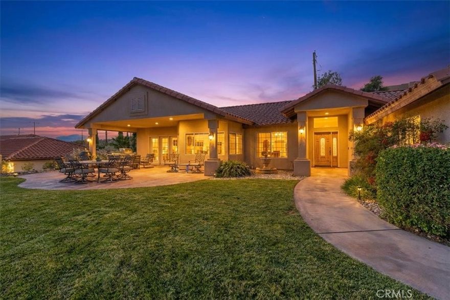 Elevated desert living awaits in this exceptional Humphreville custom home, perfectly positioned in Yucca Valley’s highly desirable Country Club Estates neighborhood. Framed by sweeping valley panoramas, this residence blends timeless craftsmanship with modern comforts to create a serene, refined home. 
Step through the doors into an expansive, light-filled interior offering 3 spacious bedrooms, a bonus room (with a custom closet) that can be used as a 4th bedroom or a home office, 2 bathrooms, a formal dining room, and an inviting breakfast bar overlooking the million-dollar view. The luxurious primary suite feels like a private sanctuary with its generous size, walk-in closet, and spa-inspired bath featuring a jetted soaking tub and separate shower.
At the heart of the home, the chef’s kitchen impresses with rich granite countertops, a gas cooktop, and upgraded stainless-steel appliances for effortless entertaining. The warm and inviting living room is enhanced by a natural gas fireplace and is prewired for surround sound.
This meticulously maintained property is equipped with premium upgrades, including radiant-barrier roof sheathing, natural gas, central heating and air, and a fully ducted evaporative cooler to save on summertime cooling. For the tech-forward homeowner, the home has an existing 5Gbps FiOS service paired with custom rack-mounted networking equipment and hard-wired Ethernet to every room.
Outdoors, enjoy a breathtaking front yard, landscaping with a full irrigation system, a private front entertainment patio with a natural gas stub ready for a future outdoor kitchen or spa, and unobstructed views that become truly magical at daybreak and sunset. A finished 3-car garage offers ample storage and convenience.
Located a short distance from the Hawk’s Landing golf course, close to town conveniences, and an easy 30-minute drive to Palm Springs, this residence captures the perfect balance of tranquility, luxury, and modern desert living.