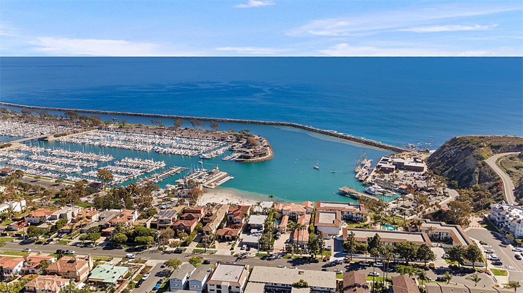 This beautiful upper-level residence is located on historic Santa Clara Avenue, one of Dana Point’s most sought-after blufftop streets just above the Harbor. Tucked in the heart of the Lantern District, this 2-bedroom, 2-bath home with an office offers approximately 1,200 square feet of elevated indoor-outdoor living. Every detail has been thoughtfully curated with high-quality materials and custom craftsmanship. Wide-plank Mediterranean French Oak floors create a warm, coastal foundation. The chef-worthy kitchen features opal white leathered marble countertops, custom cabinetry, motion-sensor lighting under open shelving, and panel-ready Bosch European appliances. Both bathrooms include elevated finishes with marble countertops, floating vanities, Italian Faetano London Series tile, and French drains. Dual Kohler showerheads provide a spa-like experience, and the primary suite boasts an oversized rainfall fixture. Motion-sensor LED lighting adds both ambiance and function. The dedicated office offers views of the lush, landscaped grounds, while both bedrooms are filled with natural light and generous closet space. Fully furnished and thoughtfully equipped with everything from linens and dinnerware to cookware and small appliances, this home is available now for a 12-month lease. Enjoy access to ocean-view amenities including a pool, spa, and clubhouse, and take full advantage of the unbeatable location. Walk to Dana Point Harbor, Salt Creek Beach, Heritage Park, Coastal Kitchen, Luciana’s, and so much more. This is the turnkey coastal lifestyle you've been waiting for.