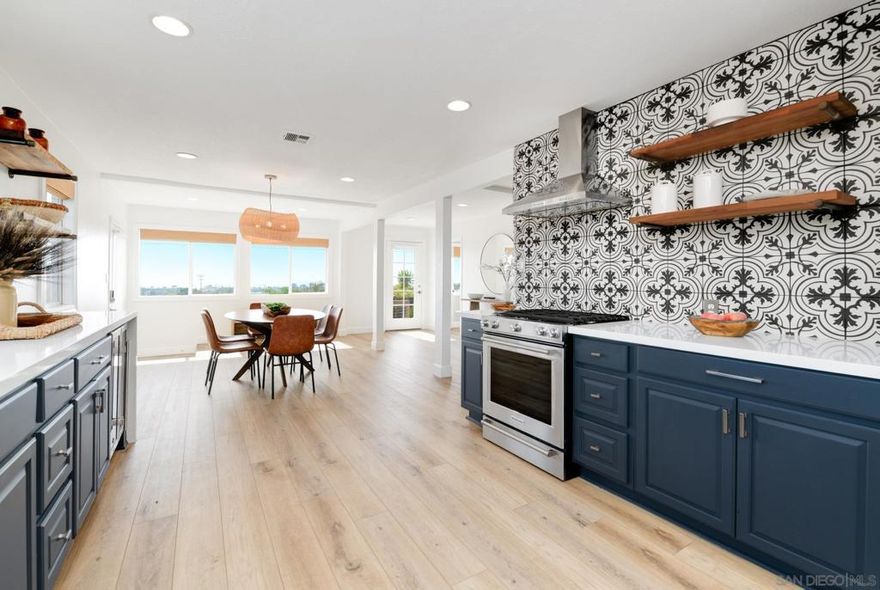 Variance granted 2-4 Units. The beautifully remodeled main residence offers 3 bedrooms, 3 bathrooms, plus an office/media room, completely redesigned in 2023. The heart of the home is the chef’s kitchen, featuring stainless steel KitchenAid appliances, a wine fridge, and elegant finishes — ideal for entertaining and daily living. Located just 2 miles from the beach. The property also includes a newly built ADU with 2 bedrooms and 2 full bathrooms, showcasing top-of-the-line finishes and its own private outdoor space.  Main House is 1,790 sq ft ADU is 1,021 sq ft.  Enjoy ocean views from the expansive backyard with an oversized deck, children’s play area and inviting fire-pit lounge. There is room to add a pool to complete your dream oasis.  Additional highlights include: Fully owned solar system, tankless water heaters for both the main house and ADU, electric car charger, heat pump in main house, upgraded electrical service to 200A (with new main panel) and outdoor shower.  For multi-generational living: The spacious main home offers 3 bedrooms, 3 bathrooms, while the newly built ADU provides a private, comfortable space for extended family or guests.  For working from home: Use the ADU as a dedicated office or creative studio, separate from the main living areas, making it easy to keep work and home life in balance — all with high-end finishes and its own outdoor retreat.  For income generation: Offset your mortgage by renting out the ADU. Easy to rent with proximity to beach and High School.  For investors: AIRBNB opportunity with multiple revenue streams.