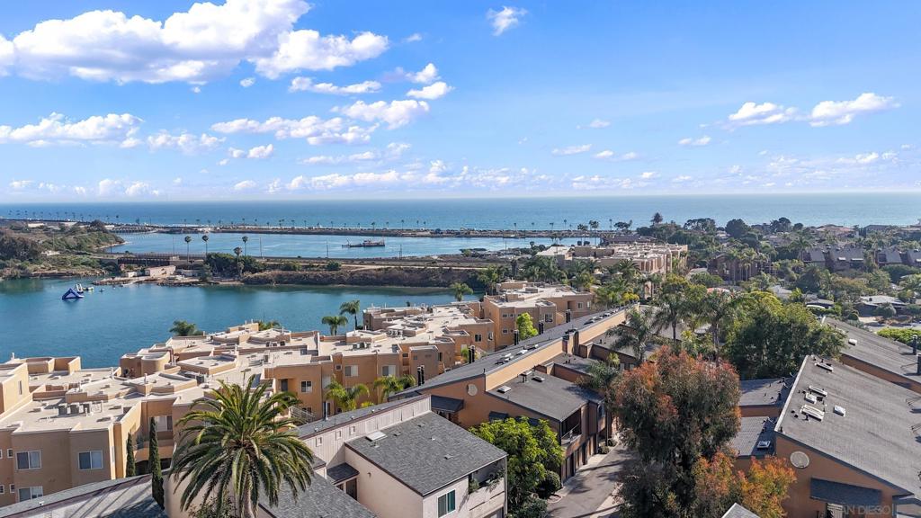 Exceptional opportunity in the highly desirable, gated Windsong Cove community of Olde Carlsbad. This beautifully maintained townhome is one of the few units in the complex offering expansive ocean views from both the living room & the primary bedroom. Fresh new paint & carpet, creating a light & welcoming interior. The open-concept living area flows seamlessly onto a private balcony, perfect for relaxing or entertaining w/ocean breezes in the background. The spacious primary suite offers a serene retreat w/its own private view balcony. Enjoy the rare convenience of an oversized second garage—ideal for additional storage, a workshop, or extra vehicle space. Lush tropical landscaping, walking paths, & resort-style amenities including a sparkling pool & jacuzzi. Just minutes to Carlsbad beaches, shopping, restaurants, & top-rated schools.