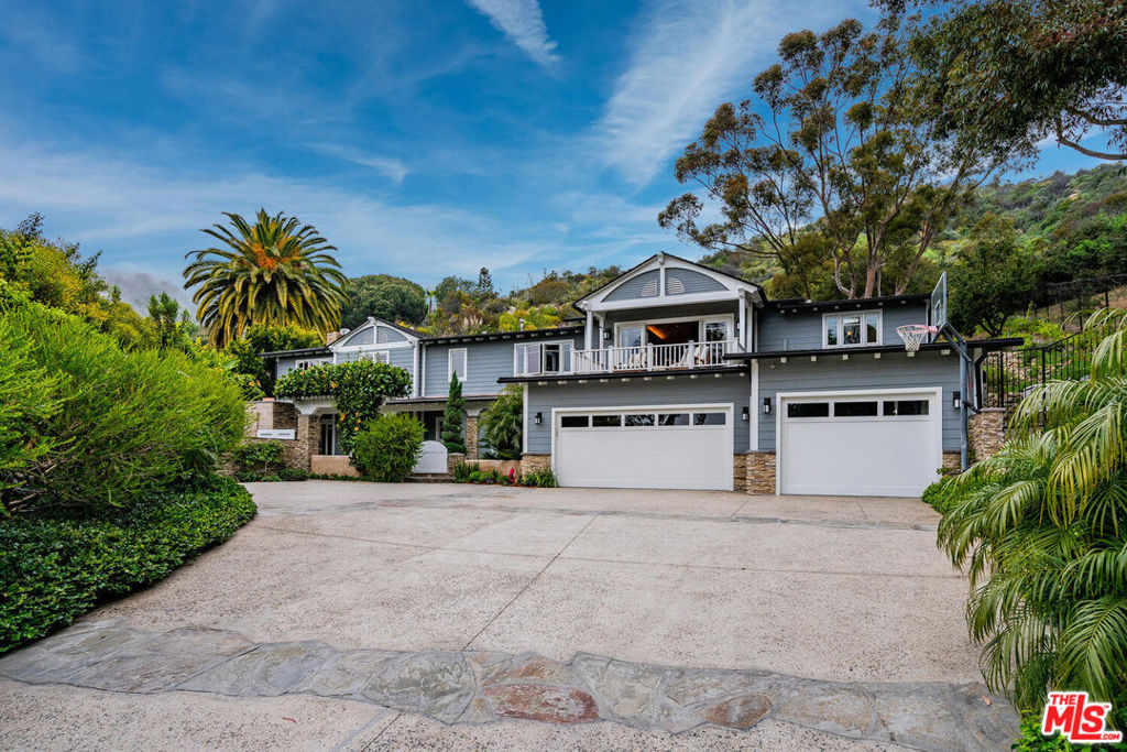 Welcome to this luxurious 5bed / 4.5 bath, 4,600 sq. ft. residence tucked away in a tranquil cul de sac within the esteemed Pacific View Estates of Pacific Palisades. This stunningly renovated property boasts captivating ocean vistas and encompasses 5 bedrooms (plus 2 offices) and 5 bathrooms, ensuring ample space for both family and guests.Upon crossing the threshold of the gated estate, you'll be greeted by a grand foyer adorned with soaring ceilings and an exquisite staircase leading to the upper level. The main floor unfolds into an expansive open-concept living space bathed in natural light streaming through expansive windows, creating an inviting and airy atmosphere. The spacious living area features a welcoming fireplace and seamlessly connects to a dining space, perfect for leisurely moments or entertaining gatherings.The heart of this home lies in the chef's kitchen, a culinary haven equipped with top-of-the-line amenities including a baking station, wine fridge, sub-zero refrigerator, and freezer drawers, complemented by elegant granite countertops and ample cabinetry. The kitchen island offers additional prep space and serves as a casual dining spot.A true highlight of this residence is the remarkable wine cellar, providing an elegant setting to display your prized wine collection. Upstairs, discover 4 bedrooms and 2 offices, ensuring privacy and comfort for every member of the household. The primary suite epitomizes indulgence, featuring a spacious bedroom with a cozy sitting area, a private deck, an office space, a lavish spa-like bathroom boasting a soaking tub and separate shower, and a generous walk-in closet.Step outside into your own private oasis encompassing a sprawling 20,000 sq ft backyard complete with a refreshing pool, rejuvenating spa, and an outdoor living room featuring a television and heaters, offering the perfect setting for relaxation or entertaining guests. The outdoor space is thoughtfully designed with ample seating, a built-in BBQ, a wood-burning outdoor pizza oven, and a fully-equipped kitchen, creating an idyllic spot to savor the Southern California climate. Additionally, revel in the serenity of your private 180-degree ocean view deck situated behind the home.Storage is abundant with a 3-car garage providing ample space for your vehicles and belongings. Conveniently located just a short drive from premier dining, shopping, and entertainment destinations, this residence offers the quintessential coastal lifestyle experience in Los Angeles.Seize the opportunity to call this exceptional abode your own and experience the epitome of luxurious coastal living.