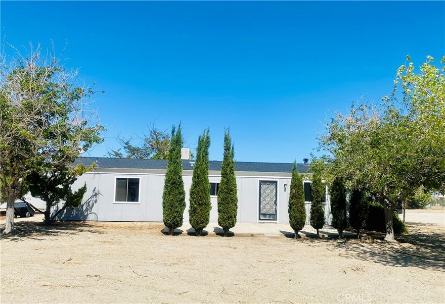 Cute 2 bedroom 2 bath manufacture home,  1248 sq ft, permanent foundation and on approximately 2.30 acres. Property has chain-link fencing, double entry gate for vehicle access and a shed for storing items. Covered back patio perfect for shaded outdoor activities with cement slab.  Mature trees, some landscaping and a fenced garden area.  Two streets to the east of paved Oasis Road, approximately 2/10 of a mile. Owner recently had interior painting completed, new carpet installed and some minor repairs completed. Take a peek, this may be the one for you!!  Thank you.