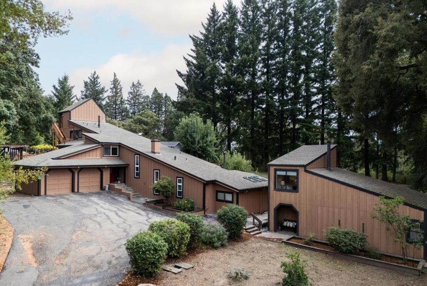 Secluded contemporary split-level in the Los Gatos Mountains, minutes from downtown, on 2.8 park-like acres along a private road with garden space, chicken coop, sand volleyball court, and equestrian possibilities within fully fenced grounds and an electric gate. The 4-bedroom, 4-bath main home plus 736 sq ft ADU with full kitchen & loft offers versatile living, abundant storage, & bonus spaces. Enter into the formal living room with a vaulted ceiling, fireplace, & built-in cabinetry. A few steps down, the lower-level primary suite features a large bedroom, sitting area with built-in window seats, flex space, wood-burning stove, & spa-inspired ensuite. On the main floor, the remodeled chefs kitchen with granite countertops & large island opens to a breakfast nook & open-concept family room with vaulted ceiling & wood-burning stove, plus a separate dining room. Three additional bedrooms include an upper-level guest suite with full bath, two main-floor bedrooms & full baths, and a dedicated office. Highlights include a loft, mudroom with laundry, oversized two-car garage with workshop, partial basement with storage or wine cellar potential, & a 24KW Generac generator. Relaxed mountain living just 5 minutes to Hwy 17, 15 minutes to downtown Los Gatos, & easy Silicon Valley access.