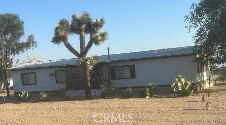 Manufactured Home on Permanent Foundation on almost 2 Arce Lot. Nicely maintained older home with minor upgrades throughout the home. Has fresh paint outside and some inside, newer metal roof, updated 2 car detached garage. Has remodeled kitchen with some newer cabinets, tile countertops, wet bar, indoor laundry. Nice for entertaining people with rear covered patio. Has storage area and fully fenced lot.