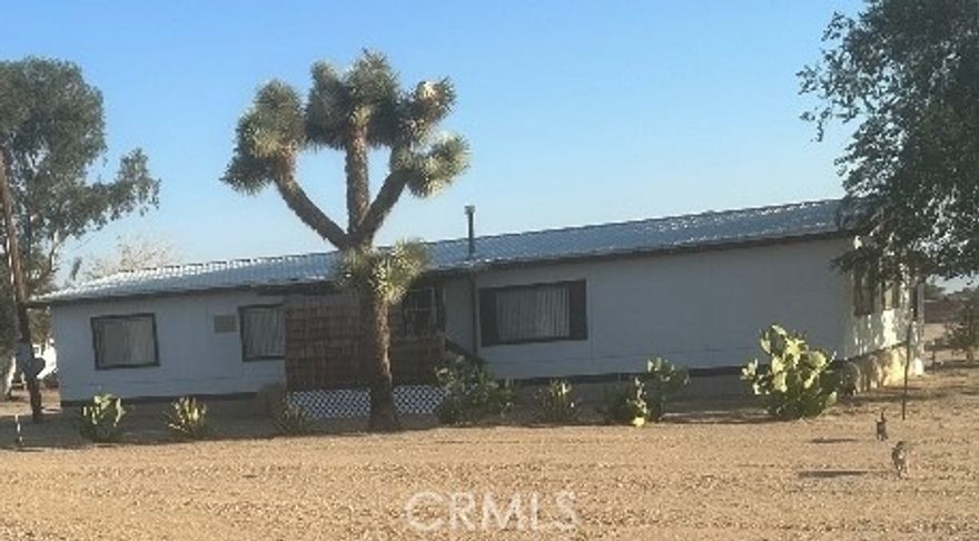 Manufactured Home on Permanent Foundation on almost 2 Arce Lot. Nicely maintained older home with minor upgrades throughout the home. Has fresh paint outside and some inside, newer metal roof, updated 2 car detached garage. Has remodeled kitchen with some newer cabinets, tile countertops, wet bar, indoor laundry. Nice for entertaining people with rear covered patio. Has storage area and fully fenced lot.