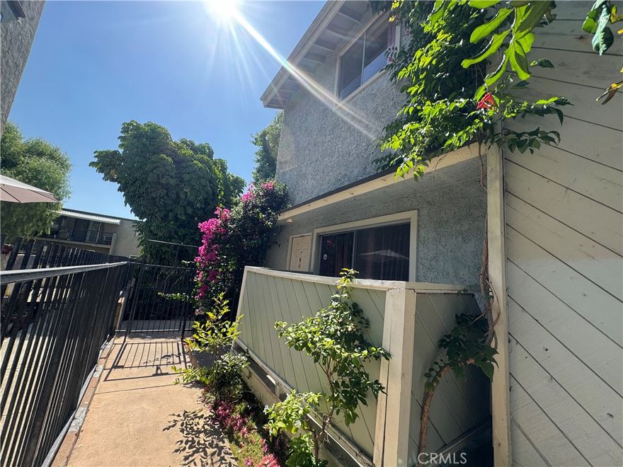 Reduced! Fix & Save! Spacious 3 Bedroom and 2.5 Bathroom Townhome! Needs Updating! End-Unit! Enter Into Large Living Room With Fireplace! Lots Of Natural Light! Slider Exit To Balcony Off Living Room! Formal Dining Area! Powder Bath On Mid-Level Floor! Large Kitchen! Room With Closet On This Level! Upstairs Features Two Big Bedrooms With Private Bathrooms! Side By Side Laundry Upstairs! Two-Car Attached Garage With Direct Access! Central AC! Low HOA! Gated Entry To Front of Units! Great Townhome! Just Needs Your Touches To Make Even Better And Just The Way You Like It!