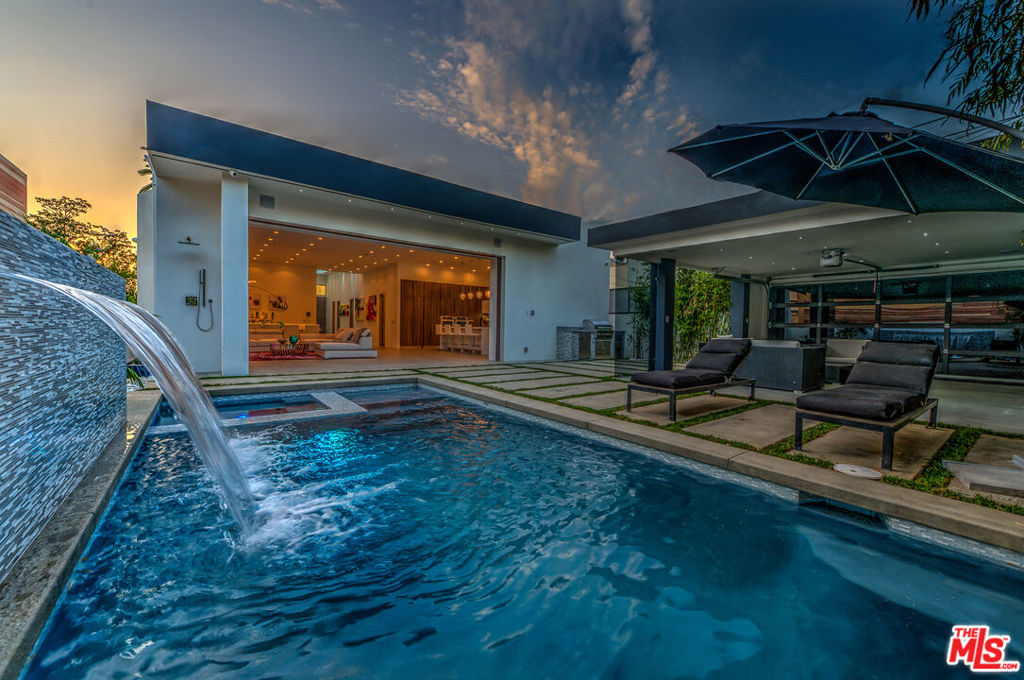 Soaring ceilings with giant skylights provide a dramatic greeting as you enter this Mansion. The designer oasis boasts, pool, spa with waterfall, custom cabinetry, built-in barbecue, outdoor shower, and cabana / flex space. This architectural gem features all top-of-the-line finishes that envelop one as soon as they're fortunate enough to step foot inside. Case in point, 'tis a truly "smart home" that allows one to control all of its dynamic functions from the touch of the wall-mounted iPad or any smart phone on-the-go. Available for long term rentals and/or short term rentals with flexible lease terms.