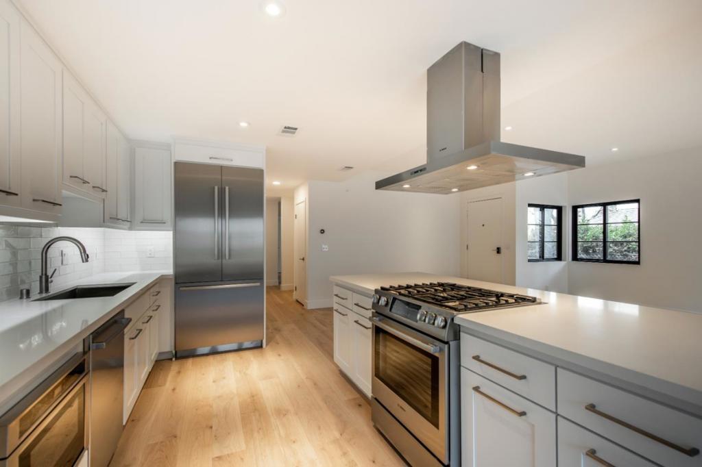 Steps to Downtown Menlo Park from this recently remodeled condominium in an exclusive small building. Spacious and light single level unit with it's own private entrance. Expansive living and dining room, 9' ceilings, open floor plan, contemporary white interior, wide plank European hardwood floors, double pane Andersen windows & doors, recessed & custom lighting. Huge chef's kitchen features island with seating and Professional Stainless Steel Appliances, white cabinetry and quartz counter tops. 2 recently remodeled bathrooms, feature white quartz & stone and tile finishes and quality chrome fixtures. Large, private wrap around balcony, ample storage space, Nest thermostat, central A/C. This is a secure building with 2 pedestrian gates and a secure garage. 2 Designated Parking Spaces, One Car Charger Dock and a Private Storage Room in garage. Large lot with professionally landscaped garden and expansive rear patio. Professionally managed building. There's nothing like this near downtown in West Menlo Park!