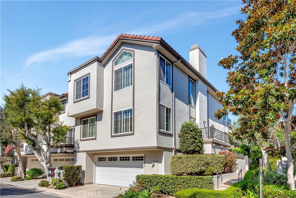 Fabulous quiet interior location for this end-unit townhome, just a 7-minute walk to the beach and steps to the pool in the ocean-close guard-gated community of SeaCliff on the Greens! Offering almost 2,300 square feet of living space, the home currently features 3 bedrooms, including one downstairs with a wet bar, plus an upstairs loft that can easily be converted to a 4th bedroom, along with 2.5 baths. Upgrades include all newer dual pane windows and sliders, updated flooring, recessed lighting, and more. The large living room showcases a cozy stacked stone fireplace and French doors that open to a balcony. The formal dining room sits adjacent to the kitchen with direct access to the private patio. The beautifully upgraded kitchen features granite countertops, stainless steel appliances, sunny breakfast nook, plenty of storage, and access to a private patio that is perfect for a BBQ. The elegant primary suite offers vaulted ceilings, cozy fireplace, a private balcony, and dual closets including one walk-in closet and one reach-in closet. The remodeled primary bath includes dual sinks, a vanity area, soaking tub, and separate shower. The spacious secondary bedroom upstairs has en-suite access to a full bathroom with tub and shower. The loft area includes built-in shelving. Additional highlights include an interior laundry room and an oversized two-car garage. The home is just steps from the community pool and spa, the beach, and the wetlands, with plenty of guest parking and a peaceful interior location.