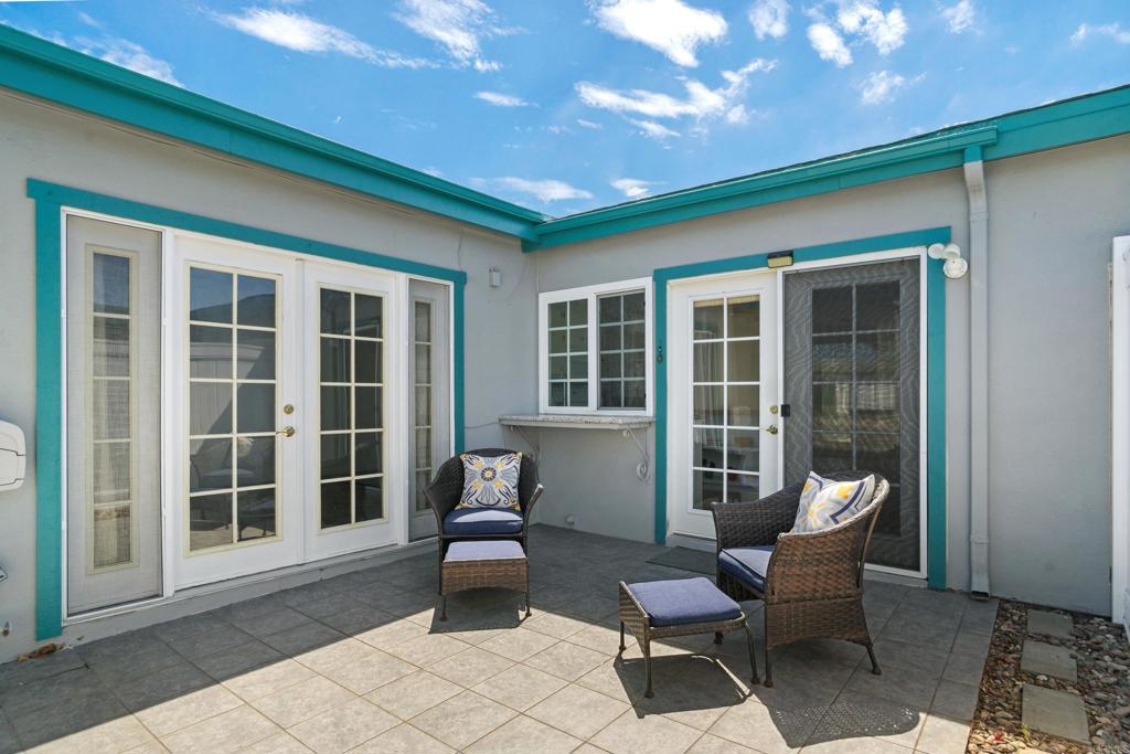 Half duplex at the top of the hill in the active 55+ Oceana Community. This home is bright and sunny with a welcoming breeze. Move in ready, 2 bedrooms and 2 FULL remodeled bathrooms, newly painted inside & out with stone porcelein tile flooring, ceiling fans, vinyl windows, custom lighting & mirrored cedar lined adjustable closets. Second bedroom has direct garage access and french doors to the patio. All appliances convey. New roof installed in 2024 with new shared fence between units. Plenty of parking w/attached garage, carport, driveway spaces plus street parking. This active Community offers pools, spa, art & card rooms, woodshop, billiards, PICKLE BALL, community garden & dog park. Emerald Isle Exec Public Golf Course offers discount green fees to Oceana residents. HOA fees cover water, trash, Cox basic cable/HBO/SHO, common area maintenance, limited insurance. Convenient to stores, library, Senior Center and public transportation.