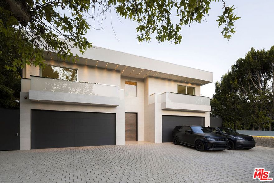 One of the best gated streets on the West Side with just 14 homes, two tennis courts & a wide street with unlimited parking. Classy double gated contemporary with dramatic canyon views, designed and built to the absolute highest level by one of Beverly Hills premier developers as his own residence within the Wallingford Estates. Featuring a total of 8 Beds & 12 baths with a separate guest house w/ approx. 2,000 SF perfect for guests, recording studio, or a company office including 2 suites, indoor & outdoor living rooms, kitchenette & a theater. Palatial master suite of approx. 2,000 sq ft with oversized his & her baths and closets, large office, kitchenette and a covered heated deck. 4 additional suites on second floor & a sixth suite with a side entrance on the lower floor. Perfectly scaled living, dining, family room & Chef's eat-in kitchen all open to the breathtaking views. Covered heated outdoor living room with a fireplace, full BBQ kitchen, cozy firepit seating for 25, outdoor dining, glass pebble infinity pool with a spa. 20 tv's & a massive sound system. 20 minutes to Van Nuys private airport and 10 minutes to the Beverly Hills hotel, minutes to gourmet market, fine shops, restaurants, salon and workout studios at the Glen Center for every convenience possible on this exclusive private enclave.