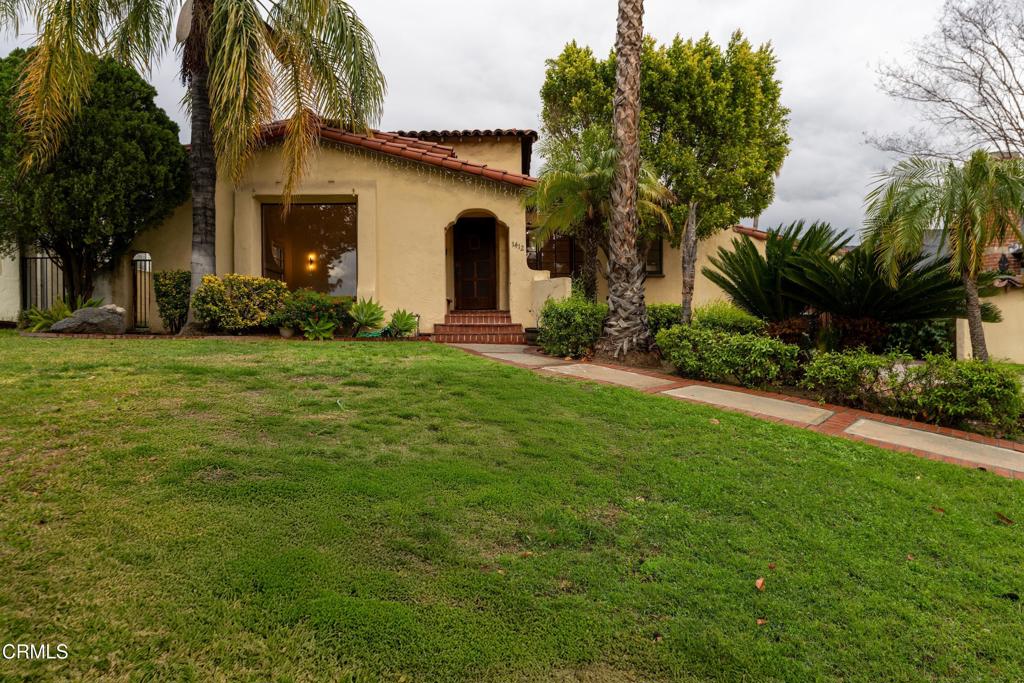 Welcome to this 1932 traditional Spanish style home in the Glenwood neighborhood of North West Glendale. Offering 4 bedrooms, and 4 bathrooms (2 full / 2 three quarter), plus a formal living and dining room, den (optional 5th bedroom), and spacious family room, the home offers many ways to utilize its great size. Upon entering, find the formal entry with tile floors and a coat closet. The spacious formal living room has high ceilings, newly refinished hardwood floors, new sconces, a large picture window, and a fireplace. Step up into the formal dining room which has a new light fixture, refinished hardwood floors, and big windows. The adjacent galley kitchen has newly painted cabinets, new countertops, newer appliances, and tile floors, plus laundry hookups. The spacious bedrooms have great natural light and new light fixtures, and the bathrooms have charming and colorful tile detail. The family room is a great space to gather, with tile floors, large windows, sliding glass doors, and a view of the rear yard and pool. The long gated driveway offers plenty of parking, and leads to a patio, and two additional storage rooms add convenience. The pool is a nice added feature along with the grassy area and patio at the rear. The home sits in close proximity to Kenneth Village with shops and restaurants, and the local high school and elementary school.