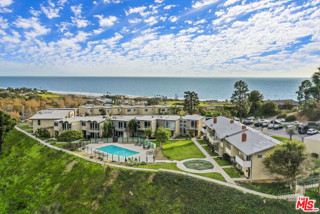 Malibu West Condo for Sale Mountain-View Retreat with Beach Club Access. Experience coastal living at its finest in this beautifully appointed Malibu West condo, ideally situated on the west end of Malibu. Enjoy stunning mountain views and exclusive access to the coveted Malibu West Beach Club. This bright and airy home offers a seamless blend of indoor-outdoor living, with a spacious living area that flows effortlessly to a private, enclosed back patio, perfect for al fresco dining or relaxing in the sun. Beyond the patio lies a well-maintained community lawn and a sparkling pool area, offering a true resort-style atmosphere. The open-concept kitchen features sleek stainless steel appliances and connects to a welcoming dining area, ideal for entertaining. Upstairs, the spacious primary suite includes a private deck with serene views over the community grounds and out to the picturesque mountains. It also features a walk-in closet and an en-suite bathroom for added privacy and convenience. Two additional bedrooms upstairs share a full bathroom, while a powder room on the main level is conveniently located near the living room. A detached 2-car garage provides ample storage, and guest parking is available both on-site and on the street. Located just minutes from Zuma Beach and Broadbeach, this home also offers proximity to local favorites such as markets, restaurants, boutiques, schools, a dog park, and recreational play fields. For active residents, enjoy access to community tennis courts and pickleball facilities. Don't miss this exceptional opportunity to own a slice of paradise in Malibu West!