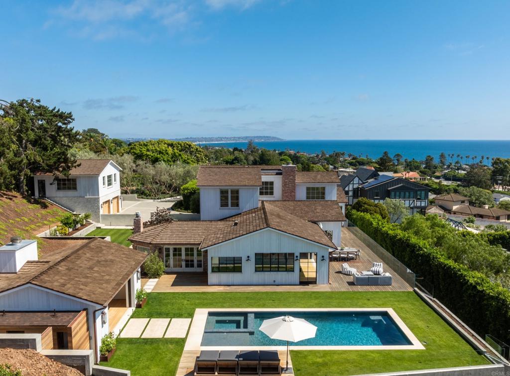 Panoramic ocean views and ultimate privacy await in this brand-new California Coastal home, ideally situated behind a gated entry on a private street in Upper Hermosa. Indulge in a lifestyle of unparalleled quality and craftsmanship, where no expense has been spared. From the Venetian plaster walls to the 9-inch European White Oak floors and high-end appliances, every detail exudes sophistication. Steel and glass windows and doors frame the gorgeous coastline, flooding the interiors with warm, natural light. The generous floor plan seamlessly blends indoor and outdoor living, opening to an impressive ocean-view deck and yard. A driveway lined with seventy-year-old olive trees leads to a welcoming entry courtyard with a fire pit, while a sparkling pool with its own pool house with fireplace promises endless hours of enjoyment. This expansive property offers an abundant living space with a six-bedroom main house, pool house and a detached one-bedroom guest house above the garage, with its own living room and kitchen. Embrace a life of tranquility and luxury in this breathtaking coastal sanctuary.