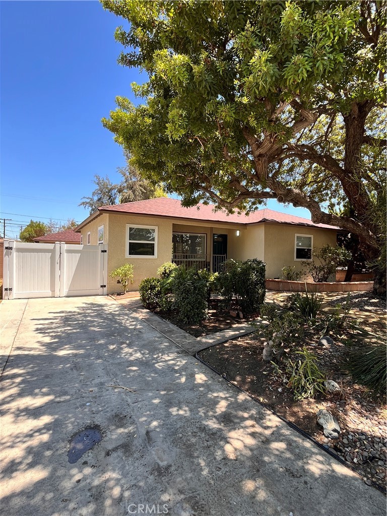 This stunning, move-in-ready home sits on a spacious, park-like lot surrounded by mature trees, offering both beauty and privacy. Thoughtfully remodeled with modern finishes throughout, the home features a sleek kitchen and bathroom, new cabinetry, and wide-plank vinyl flooring. The oversized lot provides incredible potential for future home expansion, a detached ADU or room for outdoor entertaining. A detached two-car garage with epoxy flooring adds functionality and style. Whether you’re looking for comfort, space or investment potential, this Bellflower gem delivers it all - just unpack and enjoy!