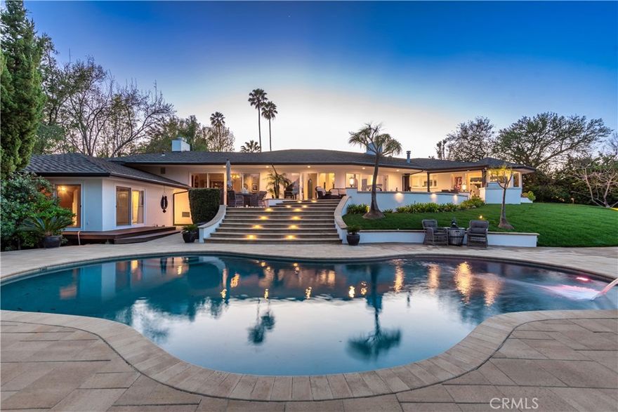 Set far back from the street and completely tucked away, this extraordinary 4,300 sq. ft. residence is a world of its own. Absolute privacy defines the property, yet the moment you arrive, the true star reveals itself: a sweeping, unobstructed valley view that will stop you in your tracks and keep you captivated from sunrise to sunset. Designed for entertaining, comfort, and effortless living, the home features five bedrooms and five-and-a-half bathrooms, with each bedroom offering its own private bath, perfect for family and guests. A long, sweeping driveway accommodates multiple cars, while two separate two-car garages provide versatile options for a private gym, a detached home office, or guest parking, blending convenience with flexibility. Step outside and your private resort comes to life: a gorgeous pool, jacuzzi, fruit trees, and your own bocce ball court create endless opportunities for fun, relaxation, and entertaining. This home comes with a vacation-like sense of ease and luxury. Move right in and start living beautifully from day one, or transform this one-of-a-kind property into the forever home you’ve always imagined. On land this rare, with views this spectacular and privacy this complete, a property like this is a rare find.