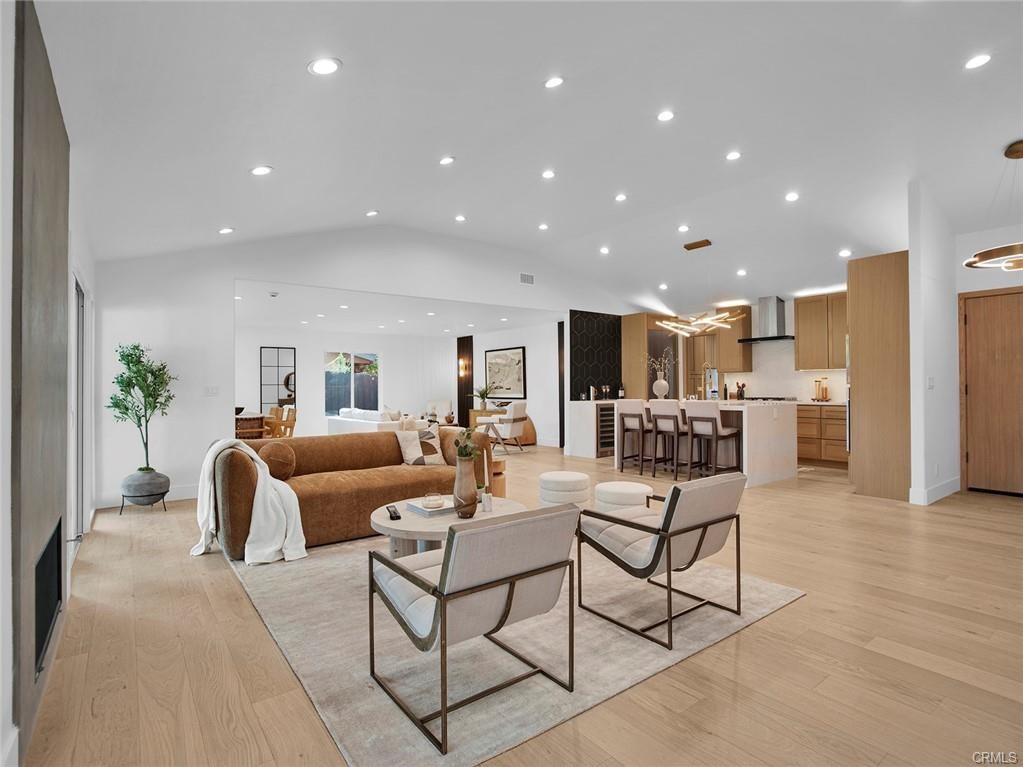 Set against a backdrop of scenic, panoramic views, this fully renovated home offers 4 bedrooms, 3 bathrooms, plus a dedicated office with 2,751 sq ft of sleek, modern living on a generous 14,380 sq ft lot in a tranquil Woodland Hills neighborhood west of Valley Circle. Thoughtfully redesigned with contemporary style and comfort in mind, the home features an expansive open layout with soaring ceilings, wide-plank hardwood floors, and abundant natural light throughout. The formal living room is anchored by a dramatic floor-to-ceiling fireplace and opens through large sliders to a covered stone patio and spacious backyard—perfect for seamless indoor-outdoor living. A large formal dining area and an additional casual living space provide flexible options for entertaining and everyday life. The gourmet kitchen is a standout, boasting a waterfall-edge quartz island, custom soft-close cabinetry, built-in appliances, and clean, modern finishes. Two en-suite bedrooms include a stunning primary retreat with its own floor-to-ceiling fireplace, walk-in closet, spa-inspired bath with dual sink vanity, glass-enclosed shower, and soaking tub, plus private access to a serene patio with outdoor shower. The expansive backyard offers lush landscaping, a large viewing deck ideal for taking in the spectacular valley and hillside vistas, and ample space to potentially add a pool or further personalize your outdoor oasis. Recent upgrades include a brand-new roof, new HVAC system, and dual-pane windows for energy efficiency and year-round comfort. Ideally located near premier shopping and dining at The Commons at Calabasas, Westfield Topanga, and The Village, with popular spots like JOEY, North Italia, Prose, and Ruth’s Chris all just minutes away. Outdoor recreation abounds with nearby Serrania Park, Warner Center Park, and the Upper Las Virgenes Canyon Preserve. With easy access to the 101 and 118 freeways and zoning for top-rated schools—Lockhurst Elementary, Hale Charter Academy, and El Camino Real Charter High School—this home offers modern luxury, exceptional views, and a coveted Woodland Hills lifestyle.