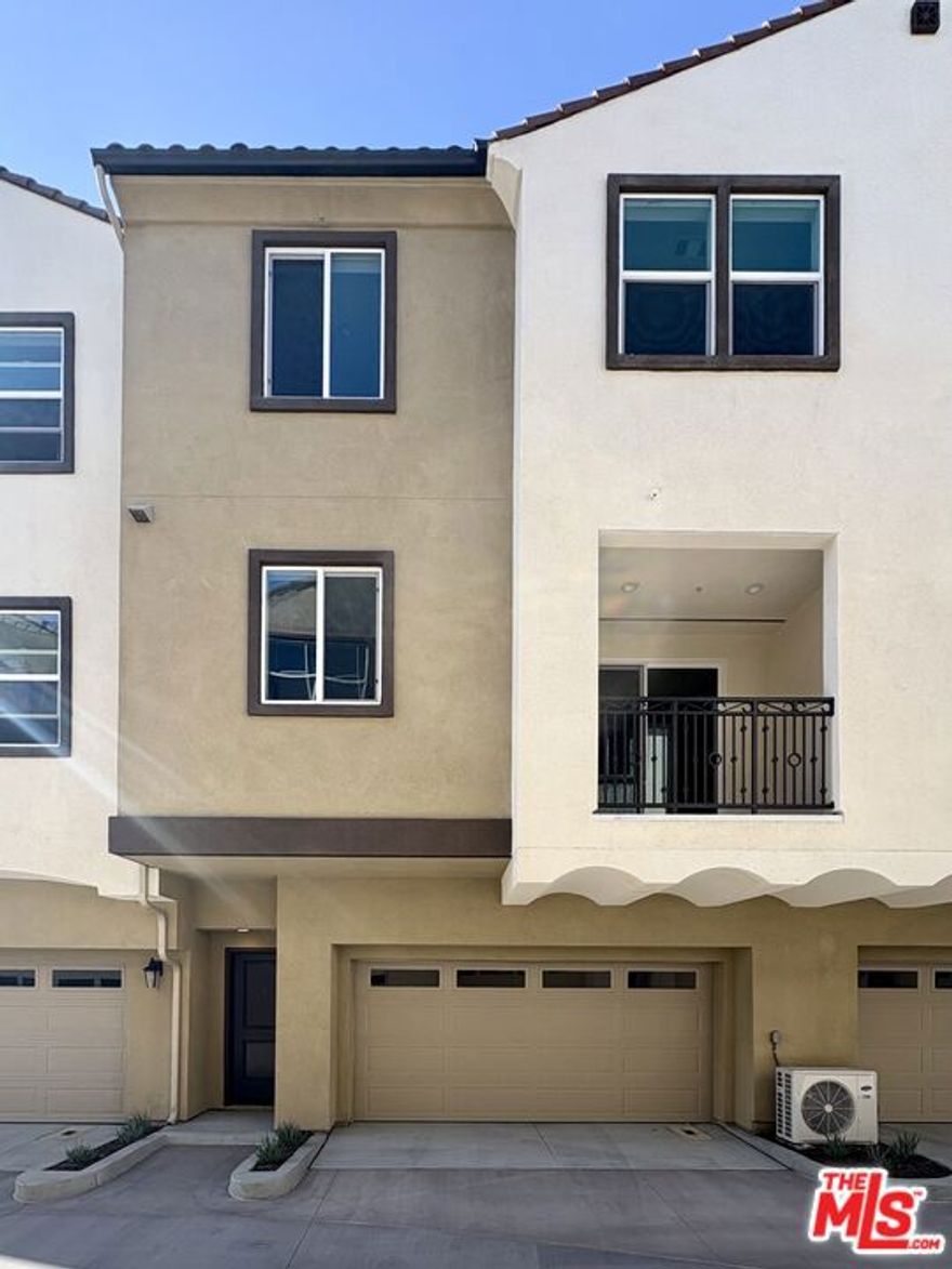 Experience refined contemporary living in this  all brand-new, elegant residence located in KB Home's exclusive Sunflower community in Anaheim. Be the very first to call this exceptional home your own! Newly constructed and thoughtfully curated, this home features an exceptional collection of premium smart appliances, including a modern refrigerator, stove, and in-unit washer and dryer, all designed to enhance convenience and efficiency. The interior showcases elegant upgraded wood flooring, a sophisticated kitchen with custom designer backsplash, upgraded fixtures, and sleek quartz countertops in both the kitchen and bathrooms. Soaring high ceilings and an abundance of natural light create an open, airy ambiance, complemented by a covered balcony off the living room, perfect for relaxing or entertaining. Retreat to spacious bedrooms with walk-in closets, and enjoy direct access to your attached garage featuring overhead storage for added convenience. The community offers ample guest parking, along with serene amenities, including a playground and well-appointed picnic areas.  A rare opportunity to enjoy fresh, modern design, and pristine new construction in one of Anaheim's newest communities. Minutes from the I-5, 57, and 91, this prime location provides effortless connectivity throughout Orange County while offering the comfort, sophistication, and ease of a modern lifestyle.