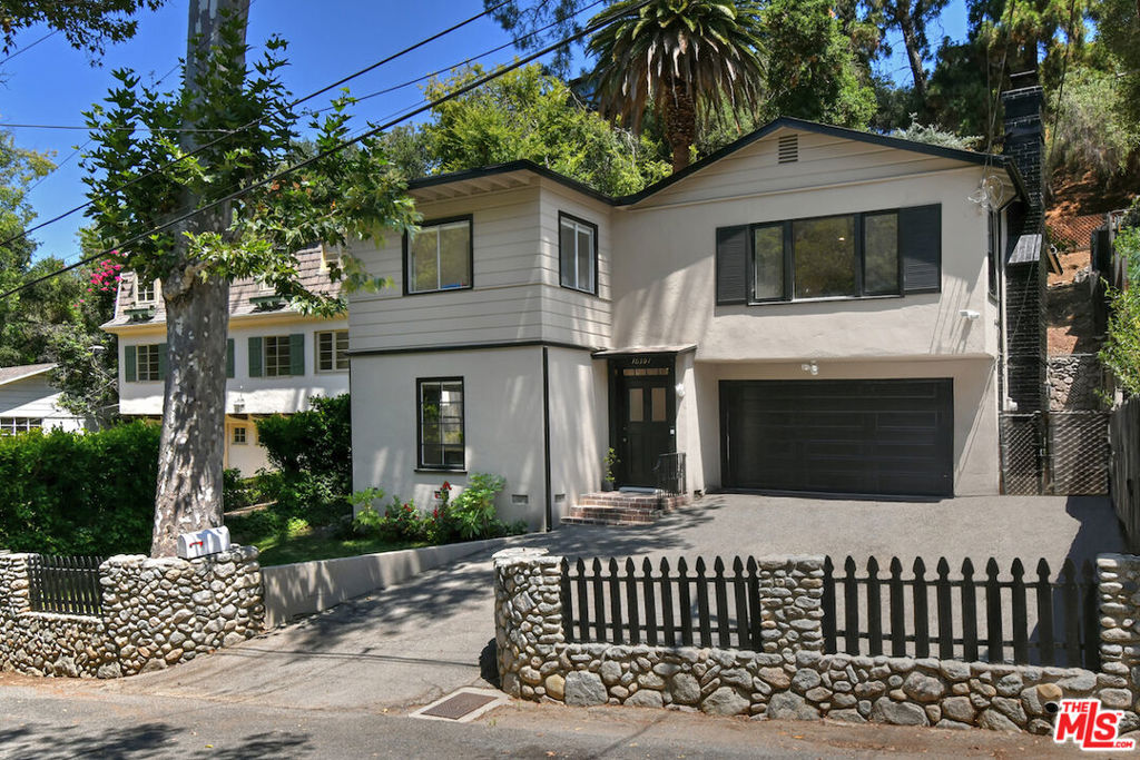 A Charming Bel Air Retreat. Nestled in a private and discreet location off Beverly Glen Canyon, this prestigious storybook Bel Air retreat is just a stone's throw away from the vibrant Beverly Glen Center. Situated a mere two miles from UCLA and minutes from the luxury of Beverly Hills Shops/Restaurants and Sherman Oaks markets, it offers the perfect blend of urban closeness and serene escape while being located on a quiet cul-de-sac. This enchanting hideaway embodies tranquility and canyon living at its finest on a large, over a 1/4 acre double lot. Bathed in an abundance of natural light, the space beckons with inviting warmth. Imagine relaxing on the expansive, terraced rear yard, where sweeping mountain and canyon views await. With 3 bedrooms and 2 full baths, this home is an artist's dream--ideal for writers, poets, or anyone seeking inspiration in a charming atmosphere. The living room, complete with a cozy fireplace, creates a memorable and inviting environment while offering breathtaking vistas of nature and mountains. This residence seamlessly combines the conveniences of city life with the serenity of rustic living. The property also offers excellent parking with space for 4-5 cars in the garage and driveway, plus room for 3 more in front of the house. It's located within the award-winning, Blue Ribbon Warner School District, with Warner Avenue Elementary School ranking in the top 5% of all California schools for academic performance. The double lot could potentially have a guest unit, artist studio or detached office built away from the house. Best of all, this is one of the lowest priced per sq. ft. single-family homes in Bel Air (90077), making it an incredible opportunity--truly a steal! Don't miss your chance to experience the magic of this remarkable home.