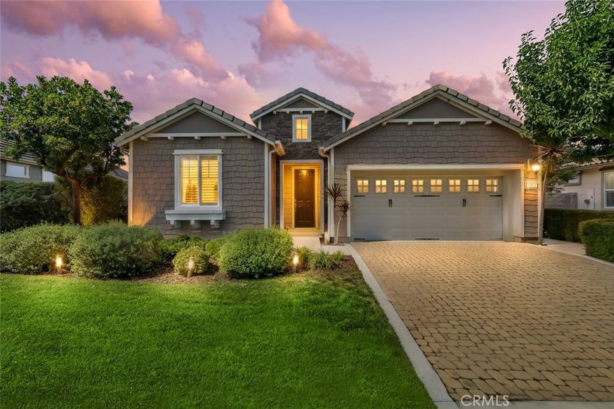 Resort living begins in this California Coastal “Nice” floor-plan home, beautifully situated on a very desirable cul-de-sac with a birds-eye panoramic view of the 5th, 6th and 7th holes of the Challenge Golf Course, plus the magnificent coastal sunsets. This 1,945 sq. ft. home, built in 2014, offers 2 bedrooms, 2 full bathrooms, plus a den with French door enclosure. Designer upgrades abound, including gorgeous hand scraped engineered wood floors, sweeping granite island with custom lighting, plantation shutters, ceiling fans and a rolling wall of glass providing exquisite views. Enter the gallery hallway and head toward the culinary kitchen - you’ll love the raised panel cabinetry, granite countertops and island, tile backsplash, JennAir stainless steel appliances, including a 5-burner cooktop and a walk-in pantry - it’s a chefs dream! Around the corner is the coveted SmartSpace/laundry, designed for optimum organization with a built-in desk, storage cabinets and countertops - it’s a great space for working from home or enjoying your favorite hobbies. Across from the kitchen is a super comfortable living room with a spacious den next door, and a large dining room with loads of natural light and incredible views. Head outside the rolling wall of glass to the covered patio - it’s the perfect spot to relax and enjoy the incredible central coast sunsets. The patio is surrounded by gorgeous, lush landscaping which frames the breathtaking golf course and lake views, and features plenty of hardscape space to entertain family and friends. Meandering pathways lead to the side yards, one outfitted with a raised garden bed. When it’s time to head indoors you can retire to your luxurious owner’s suite with a spacious bedroom which overlooks the backyard, and an en-suite bathroom with separate dual sinks, tile shower with seamless glass enclosure, and a large walk-in closet. Your guests will enjoy the comfort of their own wing with a light and airy bedroom and a full bath with tub/shower. In addition, there’s energy-efficient solar and a 2-car garage. Best of all, this spectacular home is located in Trilogy with all the amenities to fully enjoy life on the Central Coast.