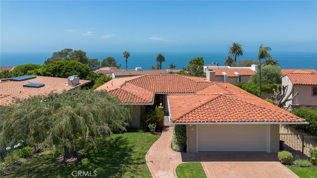 Discover the charm and lifestyle of Malaga Cove in this beautifully crafted coastal home, perfectly situated in the heart of Palos Verdes Estates. Thoughtfully designed to capture the essence of Southern California’s indoor-outdoor living, this residence boasts captivating views and expanded living spaces—ideal for entertaining, or quiet relaxation.
Begin your tour on the main level by entering an elegant private courtyard. This leads to the dining area that connects seamlessly to a beautifully updated kitchen featuring granite countertops, crisp white cabinetry, premium stainless-steel appliances, and a chef-caliber 6-burner stove. Just beyond, the light-filled living room serves as the heart of the home—warm and welcoming with hardwood floors, a cozy fireplace, and dramatic floor-to-ceiling pocket glass door that reveals a partial ocean view and opens onto a picturesque deck. The main level also features a tranquil primary suite with a private bath, alongside a second bedroom and a hallway bathroom with dual sinks.
Downstairs, the lower level expands your options with a third bedroom, an additional bathroom, a laundry room, and a versatile 4th Bedroom with its own fireplace and patio—perfect for guests, a home office, media room, or personal gym.
Additional highlights include:
• 3-zone A/C system (2 condensers)
• Updated windows and doors
• EV charger in the attached two-car garage
Located just minutes from Malaga Cove Plaza, scenic trails, renowned schools, and pristine local beaches, this home embodies the best of Palos Verdes Estates living—elegant, effortless, and ready to enjoy. Truly a rare opportunity.