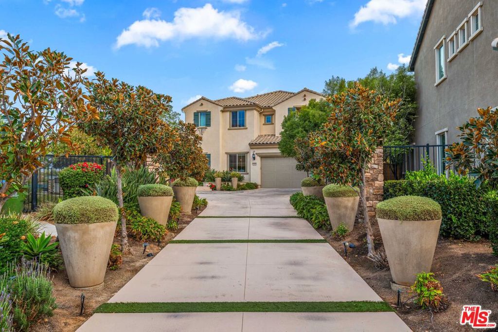 Nestled in a tranquil cul-de-sac with a long private driveway, this exceptional, FULLY FURNISHED, 4-bedroom, 4.5-bath model home offers 3,610 square feet of refined living space on an expansive 12,076 square-foot lot with plenty of room to add a pool. Designed with elegance and comfort, the open-concept layout is bathed in natural light, enhanced by soaring cathedral ceilings and expansive windows that create a warm, inviting ambiance. Chef's kitchen that is as functional as it is stunning. Boasting stone countertops, premium appliances, a generous island, and a cozy breakfast nook, it flows seamlessly into the family room for effortless entertaining. Retractable sliding doors open to a beautifully landscaped backyard oasis, complete with a built-in grill, outdoor fridge, mesmerizing fire pit, tranquil water features, and custom waterproof patio roller shades-ensuring comfort in any season. Thoughtfully designed for modern living, the home features top-tier amenities, including a state-of-the-art surround sound system, remote-controlled custom shades, and a versatile first-floor office with an ensuite bedroom, perfect for guests or work-from-home flexibility. Upstairs, the luxurious primary suite is a private retreat. It offers dual walk-in closets and a spa-inspired bathroom with dual vanities, a freestanding soaking tub, and a walk-in shower with multiple showerheads. A covered balcony extends the suite, providing serene views and remote-controlled access for ultimate convenience. Two additional spacious bedrooms, a large laundry room, and a versatile bonus loft complete the second floor. Practicality meets style with a three-car garage finished with scratch-resistant epoxy flooring, while a commercial-grade water softener and exquisite finishes throughout the home elevate its sophisticated appeal. Experience the ultimate California lifestyle in this remarkable West Hills Sterling Community residence designed for everyday comfort and unforgettable entertaining. A must-see!