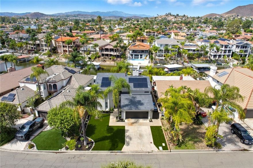 Price reduced!!! Remodeled by one of Newport's award winning, "builder of the year" recipients! This home is a beautiful love story--a truly exceptional lake front and cul-de-sac home that boasts impressive and thoughtful craftmanship. Fully remodeled by a skilled general contractor for and with his wife, a celebrated designer. Together their vision blends timeless style, thoughtful, modern luxury and functionality. The gourmet kitchen is a chef’s dream, featuring dreamy Z-line appliances, quartzite counters, custom cabinetry with pull-outs and soft close features, smart storage solutions, specialized racks for corner access, and dedicated compartments for everyday necessities like trash bags that are stored over the trash can. Enjoy the views but do not miss the custom wine storage tucked under the stairs or the 3rd car tandem garage that was converted to a home gym. Upstairs find two bedrooms plus the primary bedroom, each with cathedral ceilings. The upstairs bathroom is worthy of any five star hotel or spa and is only rivaled by the primary suite (oh that closet!!!!) that looks like it is out of Architectural Digest! Solid surface flooring throughout the entire house! Gather with friends and family in multiple entertaining areas, or dine al fresco under the covered patio as the sun sets over the lake and surrounding mountains. Outside, enjoy low maintenance artificial turf, water views, lakeside lounging, direct boat access and more. Such a love story has to include morning coffee while feeding your new duck friends as they stroll by your waterfront seating area... Did we mention solar and new roof? This home includes a 13.54KwH peak capacity solar system (owned, not leased) and a new concrete tile roof.  This home is designed for vacation and everyday living. New to Canyon Lake?  This community offers an 18 hole golf course, 400 acre private lake, campground facilities, multiple restaurants (Sunset Lounge, Lighthouse Restaurant & Country Club Bar & Grill), a Jr Olympic sized pool + kid's pool, equestrian facilities, over 15 parks and beaches, six pickleball courts, tennis courts & clinics, multiple baseball fields, a senior center and a community garden! Offers may include an option for furnishings, the new boat and the six-seater Onward golf cart. It is your turn to fall in love.