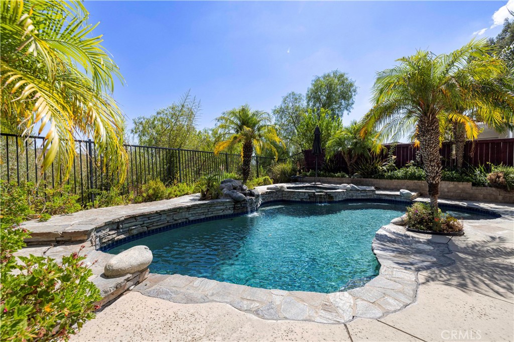 Welcome to this stunning Castaic POOL HOME offering nearly 3,500 sq. ft. of flexible living space! With the potential for up to 6 bedrooms, this home adapts beautifully to your needs. Downstairs, you’ll find a private office that could easily be converted to a bedroom with the addition of a closet, while upstairs features a spacious loft—already equipped with a closet—that makes a perfect extra bedroom, game room, or second family room.
From the moment you enter, you’re greeted by a bright formal living and dining area. The family room, complete with a cozy fireplace, flows seamlessly to the backyard for easy indoor-outdoor living. The chef’s kitchen is a true highlight with a center island, breakfast nook, expansive counters and cabinetry, a walk-in pantry, and picturesque views from nearly every window. A separate laundry room with sink, abundant storage, and side-yard access adds everyday convenience. Upstairs, the oversized primary suite offers a retreat-like feel with its own fireplace, walk-in closet, and ensuite bath featuring dual sinks, a soaking tub, and separate shower—all with gorgeous views. Three additional bedrooms share a large full bath with dual sinks, while the generous loft offers endless options. Step outside and discover your private backyard paradise, complete with sparkling pool and spa, lush landscaping, and breathtaking views. With no HOA or Mello Roos, and located just minutes from the 5 Freeway, shopping, dining, and schools, this home truly has it all.