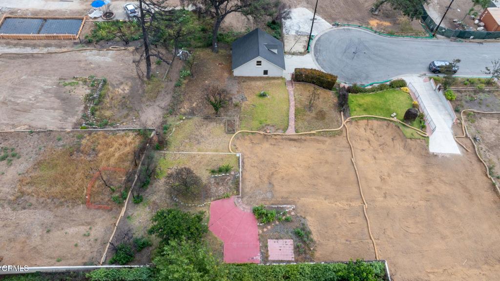 Located at the end of a quiet cul-de-sac, 281 E Pentagon sits on a private 11,232 square foot lot set behind a mature hedge and filled with traces of a life well-lived. A two-story, detached two-car garage remains standing, once home to an art studio where stories were shared and creativity unfolded across generations. This site was once part of the early 20th century Pentagon Ranch, a citrus and avocado orchard whose presence still lingers in the land. Several fruiting trees remain, and the property once supported a navel orange, persimmon, fig, and multiple avocado varieties. Birds still move through the canopy, and the setting carries the quiet, abundant feel of an urban farm. It is close to the city but grounded in something simpler. 281 E Pentagon offers space, privacy, and a connection to both history and nature. Whether reimagined for a new chapter or shaped with a nod to what came before, the setting invites something personal to take root. This was once the site of a three-bedroom, two-bathroom home with 1,621 square feet of living space. With Phase 2 debris removal complete, the site is cleared and ready for what comes next. The property is being sold as land only.