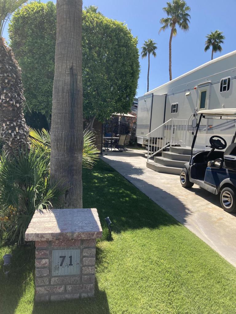 Lot 71 boasts a charming atmosphere, serene patio, and vibrant private setting. Mature greenery provides a shaded area for relaxation. It's conveniently located near the entrance and La Palma clubhouse. *RV sold, *golf cart negotiable.
