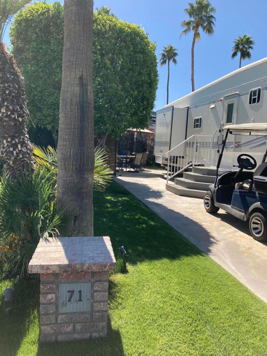 Lot 71 boasts a charming atmosphere, serene patio, and vibrant private setting. Mature greenery provides a shaded area for relaxation. It's conveniently located near the entrance and La Palma clubhouse. *RV excluded, *golf cart negotiable.