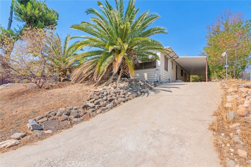 Spacious 3 bedroom, 2 bath manufactured home on its own land in Gavilan Hills! Offering 1,660 sq ft of living space on a 1/3 of an acre lot, this single-story home features an open floor plan, newer vinyl wood flooring, and a bright living room that flows into the dining and kitchen areas. The kitchen offers plenty of cabinet space, gas range, and a separate laundry room. The large primary suite includes dual sinks, soaking tub, and walk-in shower. Secondary bedrooms are generously sized. Outside, enjoy a fenced backyard, hillside views, and a huge covered carport running the length of the home, perfect for multiple vehicles, RV, or toys. Quiet rural setting, yet close to Cajalco Rd, shopping, schools, and freeway access. No HOA, low taxes, and room to create your ideal outdoor space. This home does NOT qualify for traditional financing (NO FHA, VA, USDA or CONVENTIONAL) due to the age.