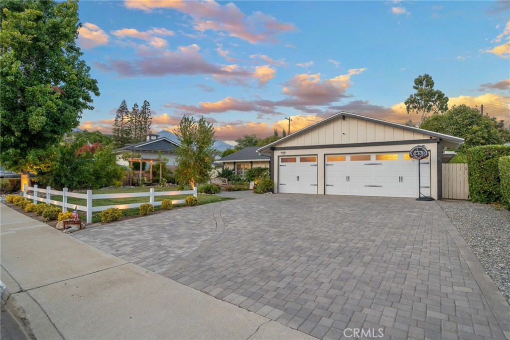 PAID-OFF SOLAR & Newer Roof! Welcome to 2240 La Sierra Way, a beautifully upgraded California Farmhouse. This home is equipped with 34 paid-off solar panels and countless upgrades throughout its 2,037 square feet. Features 4 bedrooms plus an office (or optional 5th bedroom) and 2 remodeled bathrooms. The expansive driveway with custom brick pavers and matching walkway delivers serious curb appeal as it leads up to the double-door entry. An open-concept floor plan awaits with abundant natural light and tasteful shiplap feature walls in the entry and family room. The fully remodeled kitchen offers maple cabinetry, granite countertops, double ovens, a stainless steel hood range, and soft-close, pull-out drawers in cabinets for maximum convenience. The spacious dining room, with its stunning Andersen French double sliding doors, is perfect for entertaining. Plantation shutters, dual-pane windows, LED recessed lighting, ceiling fans throughout, brick fireplace, and beautiful hardwood floors add warmth and style throughout. The primary suite includes custom cabinets, a vanity area, and a luxurious full glass steam shower. From the kitchen, you’ll enjoy direct access to an extended and finished 3-car garage with epoxy floors, recessed lighting, AC, it's own sub-panel, 220V outlet, and attic storage access. Outside, the secluded backyard offers privacy and is a showstopper, with a towering greenery-covered wall, built-in wood-burning fire-pit, custom brick and concrete hardscape, and a charming walkway to an upper corner patio. The Alumawood patio cover includes recessed lighting and a ceiling fan, perfect for relaxing evenings. Two large Tuff Sheds and a jacuzzi spa remain with the property, and a brand-new block wall lines the north side of the yard. The front yard offers multiple electrical outlets and under-eave wiring for holiday lights or exterior décor. With a water conditioner system and upgrades at every turn, this home truly has it all. Plans for a JR ADU Included. Don’t miss your chance — contact us today to schedule your private tour!