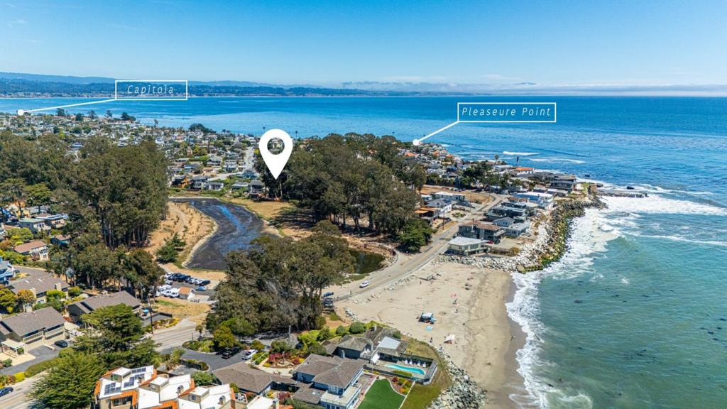 Create your future coastal legacy today. Nestled right in the heart of iconic Pleasure Point, a world-famous surf destination along CA's breathtaking Central Coast, this once in a lifetime property offers panoramic views over Moran Lake & Beach, w/ peeks of Steamer Lane & the lighthouse. Just a few blocks from the East Cliff Promenade, this 3BD, 2BA serves as the perfect blank canvas to bring your vision to life. Design & build your dream retreat in one of SC's most coveted locations. The expansive 6,970 SF lot provides exceptional privacy & space, while keeping you close to the action. From your doorstep it's a hop, skip, or skate to Pleasure Point Surfing & The Point Market. Head down East Cliff Drive for dramatic ocean vistas, or stroll up 41st Avenue to enjoy Verve Coffee, East Side Eatery & all the vibrant boutique shops & fav local restaurants nearby. Walk or bike everywhere worth going from the Sanctuary Trail all the way to The Hook, or to the beach stairs that set you right onto the sand. Endless possibilities to transform this property into your own personal haven, a place to welcome family & friends. Attached garage, ample parking, & plenty of storage for boards, bikes, & beach gear. Opportunities like this don't come around often. Come for a surf, stay for a lifetime.