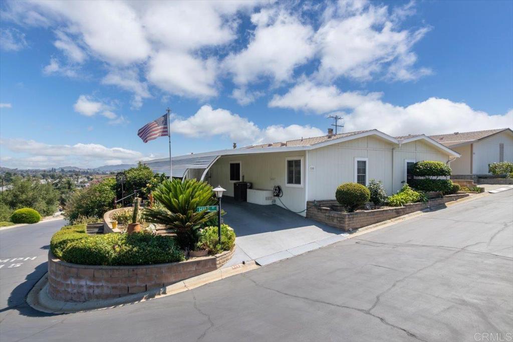 Welcome to the Foothills of San Marcos! Perched on a premier corner lot at the top of the hill, this land-owned manufactured home offers stunning panoramic views and an exceptional lifestyle. With 2 bedrooms, 2 bathrooms, a bonus room, and a sunroom, the spacious open layout is perfect for comfortable living and entertaining. The custom-renovated kitchen features a walk-in pantry and opens seamlessly into a large living area anchored by a beautifully crafted fireplace. Enjoy foothills and community views from nearly every window—this truly feels like the best lot in the community. Additional highlights include an indoor laundry room, generous natural light, and multiple indoor/outdoor living spaces. Residents enjoy a low HOA fee that includes access to a welcoming clubhouse, pool & spa, tennis courts, and community solar rebates. This is more than just a home—it's a vibrant, social lifestyle in one of San Marcos’ most desirable 55+ communities. Come experience the beauty, comfort, and connection that this home offers.
