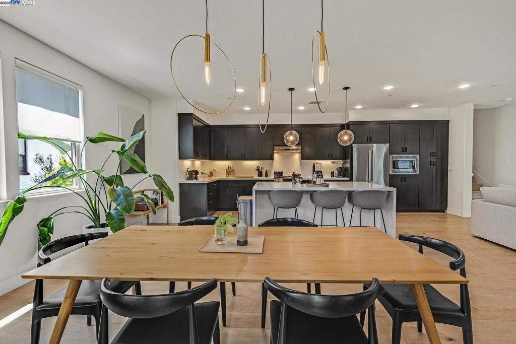 Rare opportunity to own in Alameda Landing! This upgraded 3-bed, 2.5-bath, 2,248 sq ft home stands out from the rest. Elegant European white oak floors flow throughout the entire home, creating a welcoming ambiance. The open concept main level showcases a stunning waterfall kitchen island and premium appliances, perfect for gatherings and easy entertaining. Enjoy spacious living and dining areas, ample natural light, and two private balconies, one perfect for BBQs and one perfect for chilling amongst the trees. Upstairs, the serene owner's suite features a private balcony along with a spa-like bath and walk-in closet. Two additional bedrooms and a convenient laundry closet complete the upper level. The community is kid and dog-friendly, with access to the largest private park in the HOA and several green spaces. Safeway, Target, shops, and restaurants are right across the street or elect to go the other direction and enjoy the close-by "Spirits Alley" featuring Breweries, wineries, and distilleries. Quick access to ferries makes commuting to BART, Jack London Square, and San Francisco restful and fun! Two-car garage, top-rated schools, and a vibrant neighborhood make this home a must-see. This one won't last long... come and experience it for yourself!