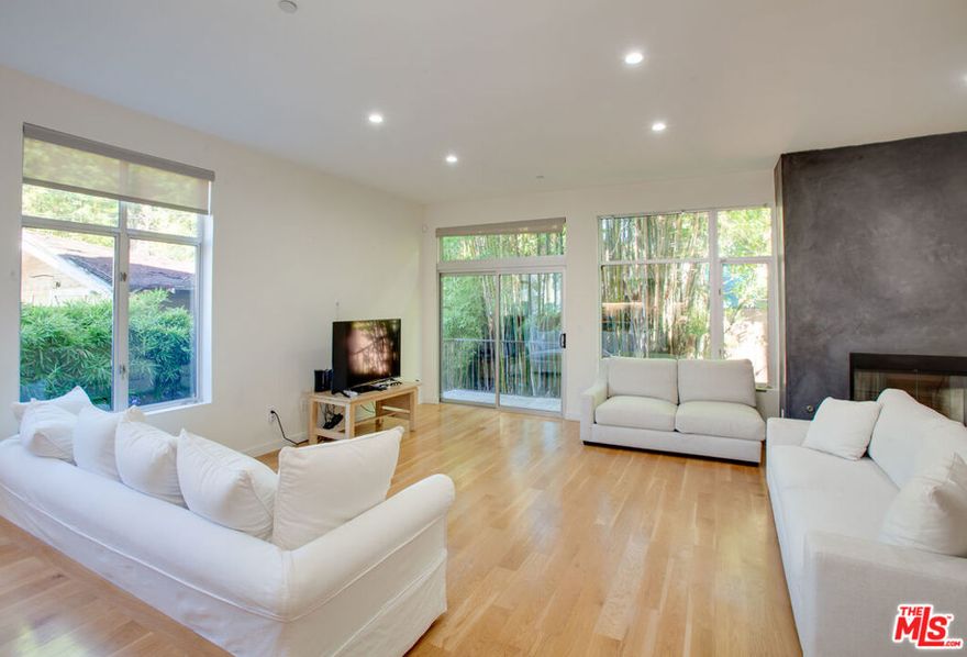 This stunning architecturally designed townhouse, is located in the heart of West Hollywood, walking distance to restaurants, shopping and all the entertainment the city has to offer. One of only six unit townhomes, this 3 bed / 2.5 bath spacious and light filled home, boosts an open floor plan, featuring soaring high ceilings, recently remodeled gourmet kitchen with Viking appliances and white oak cabinetry, hardwood flooring throughout, as well as fully remodeled bathrooms with excellent designer finishes. Further features include large master suite, ground level private back yard and roof top terrace with stunning views of the city lights and Hollywood Hills.  Also a private garage in the secured parking area has direct private access to the unit, along with a recreational room.   A beautiful and spacious home in an excellent location, making city life the best it can be.