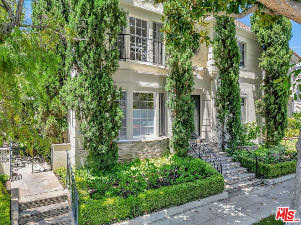 Step into this Beverly Hills sanctuary as you meander through a fountain kissed, romantic courtyard into this trophy condo. Positioned on the second floor at the front of an intimate, four unit building, this luxurious condo marries restored vintage character, soaring ceilings with plaster crown moldings, gleaming hardwood floors, traditional wainscoting, chandeliers and sconces with modern comforts throughout. Sunlight pours through charming windows, illuminating two oversized bedrooms. The generous bathroom with an alcove shower showcasing a freestanding clawfoot tub worthy of old Hollywood starlets. Entertain in style within the formal dining room or whip up gourmet meals in the chef's kitchen, complete stainless steel appliances and a gas cooktop. Secure garage parking ensures privacy and peace of mind. Top rated Beverly Hills schools underscore the unbeatable value of this rare pied terre. Located in the heart of prime Beverly Hills, you'll be steps from designer boutiques, artisanal cafs, world class dining on Rodeo Drive, and every neighborhood gem that makes this city legendary. This sun soaked, character filled condo offers the perfect blend of elegance, convenience, and quintessential Beverly Hills lifestyle.