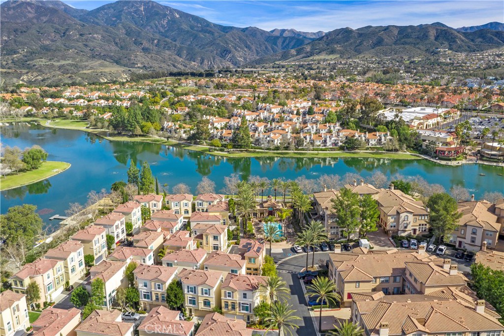 Just in time for summer, enjoy this private end unit located in the Montana del Lago community surrounded by RSM Lake, the Beach Club & Lagoon, shopping, and restaurants. Desirable dual suite floorplan with 2.5 baths and vinyl flooring. Kitchen overlooks the dining area and features plentiful storage, gas range, stainless steel refrigerator and microwave. Dining area also opens to the living room with fireplace and entertainment nook. Spacious primary suites both with high ceilings, dual sink vanities and soaking tub. Enjoy the large front patio which can easily accommodate a BBQ and table and chairs for outside dining or entertaining. Inside laundry and direct access 2 car garage complete this condo. Enjoy the RSM Lake 4th of July with fireworks from your own backyard.