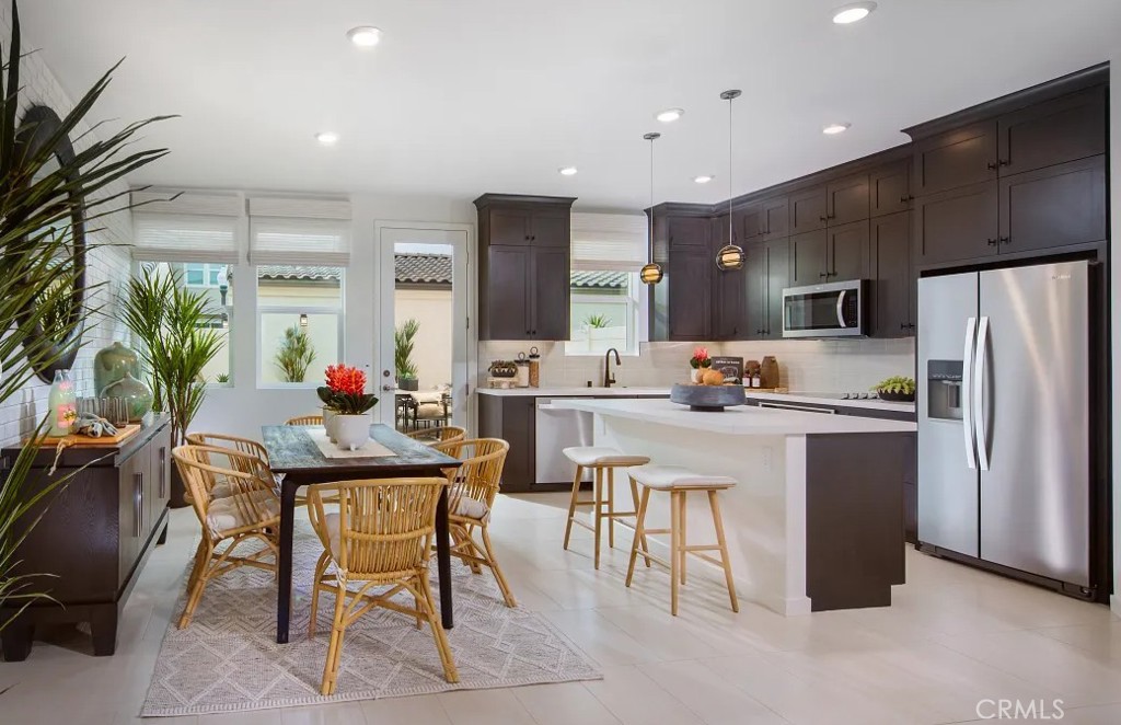 Open concept three bedroom with 2.5 bath condo. Kitchen is upgraded with quartz countertops, designer backsplash ,and KitchenAid stainless appliances. Upgraded flooring throughout. Custom tile in primary shower. This unit has its own backyard and a two car detached garage.