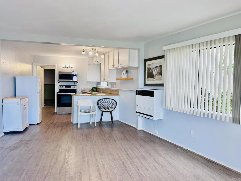 Charming Coastal Retreat with Spectacular Ocean Views – Dana Point Experience the best of coastal living in this beautifully updated and spacious 1BD/1BA ground-floor apartment, located in a highly sought-after Dana Point oceanview four-plex. Offering approximately 950 sq. ft. of light-filled living space, this inviting residence boasts a seamless open-concept layout and an unbeatable location. Step through a picturesque private stone walkway and into a bright, airy interior freshly painted in soothing neutral tones with sleek laminate flooring throughout. The sun-drenched living and dining area flows effortlessly onto a generous 10' x 12' private balcony, offering breathtaking, unobstructed ocean views — perfect for relaxing or entertaining. An elegant shared flagstone patio provides additional space to enjoy the outdoors. The kitchen features polished granite countertops, and comes equipped with an electric range, built-in microwave, and refrigerator —ideal for easy coastal cooking. The well-appointed bathroom includes a stylish vanity, a shower/tub combo, and ample built-in storage. Retreat to the expansive 15’ x 19’ bedroom, privately located at the rear of the unit, featuring dual oversized walk-in closets and plenty of natural light. Additional highlights include a private, attached single-car garage with direct access, on-site laundry facilities, and extra dedicated storage. Enjoy quick and convenient access to the freeway, shopping, restaurants, and the vibrant Dana Point Harbor—just a 4-minute drive. Nestled just east of Pacific Coast Highway, this home offers the perfect blend of serenity, style, and location. **Available now for private showings—contact listing agent today!**
