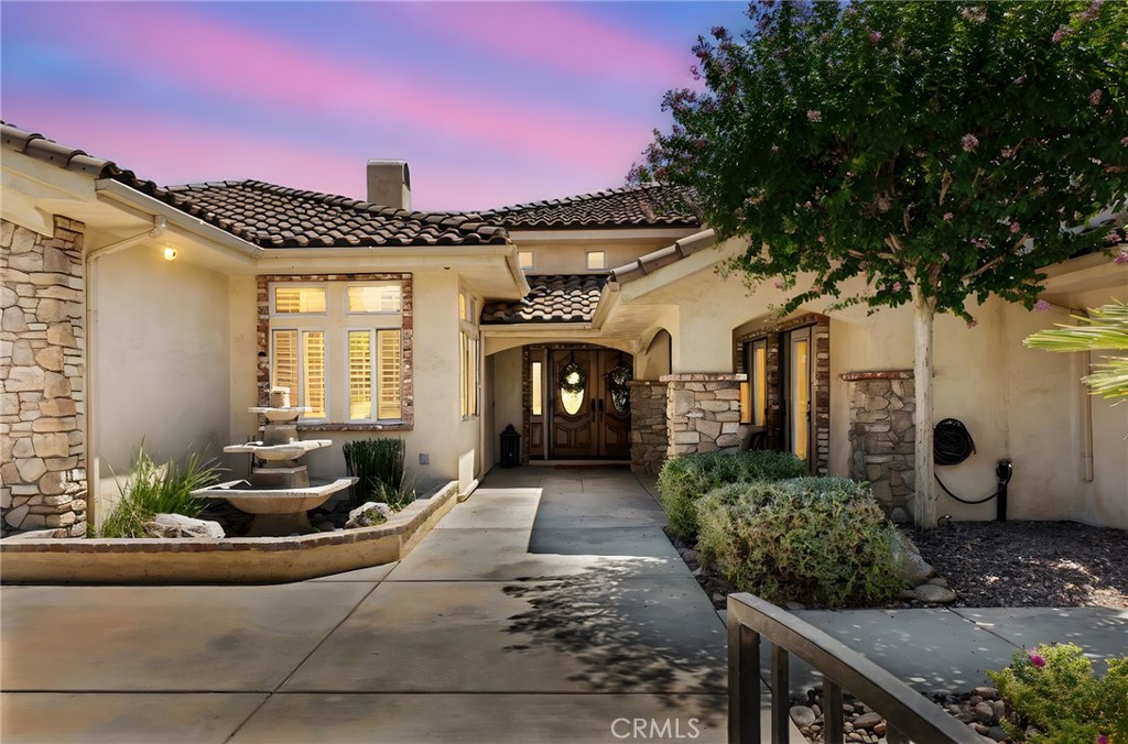 Experience refined Tuscan living at 19163 Kanbridge St, nestled in the esteemed Stonebrook Estates of Apple Valley.
This impressive 3,873 sq ft single-story estate blends timeless architecture with modern luxury. The thoughtfully designed layout features four spacious bedrooms and three-and-a-half baths, offering both privacy and comfort for family and guests alike.
The heart of the home is a chef’s dream kitchen, fully outfitted with top-of-the-line Viking appliances that make cooking a true pleasure. Generous living areas, elegant finishes, and an inviting flow create the perfect setting for entertaining or simply enjoying life at home.
Step outside to your private .47-acre oasis, where resort-style amenities await. A fully loaded custom outdoor BBQ area sets the stage for unforgettable gatherings, while the personal putting green offers endless hours of leisure and fun. Mature landscaping and spacious patios complete the picture of outdoor perfection.
With a three-car garage, distinguished curb appeal, and a premier location within one of Apple Valley’s most sought-after gated communities, this home is a rare find that delivers both elegance and lifestyle in equal measure.