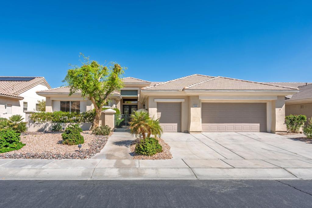 Sun City Palm Desert - Monaco. Ideally located in the heart of the development, this sought-after estate model offers generous indoor and outdoor living spaces designed for comfort and style. The north-facing backyard features an extended patio surrounded by lush desert landscaping and peekaboo mountain views--ideal for relaxing or entertaining. A gated front courtyard with leaded glass double doors adds impressive curb appeal. Inside, soaring 12-foot ceilings in the great room and 10-foot ceilings throughout create an open, airy feel. The great room boasts a double slider to the patio, while diagonally laid tile flooring and plantation shutters enhance the home's elegance. The family room includes a custom built-in media center and recessed lighting. The chef's kitchen offers a center island with breakfast bar, Corian counters with rounded edges, maple cabinetry, a large pantry, and a skylight for natural light. An extended primary suite features patio access, a spacious walk-in closet with built-ins, and a spa-like bath with dual sinks, an oversized soaking tub, and a glass-enclosed shower. Two private guest bedrooms provide comfort for visitors--one with an ensuite bath and built-ins, the other extended with direct access to the courtyard. The oversized laundry room includes abundant cabinetry, a utility sink, and space for a second refrigerator. The extended 2-car plus golf cart garage is equipped with built-in storage and a utility sink. Additional highlights include dual-zone AC (one unit new in 2018, the other in 2014).