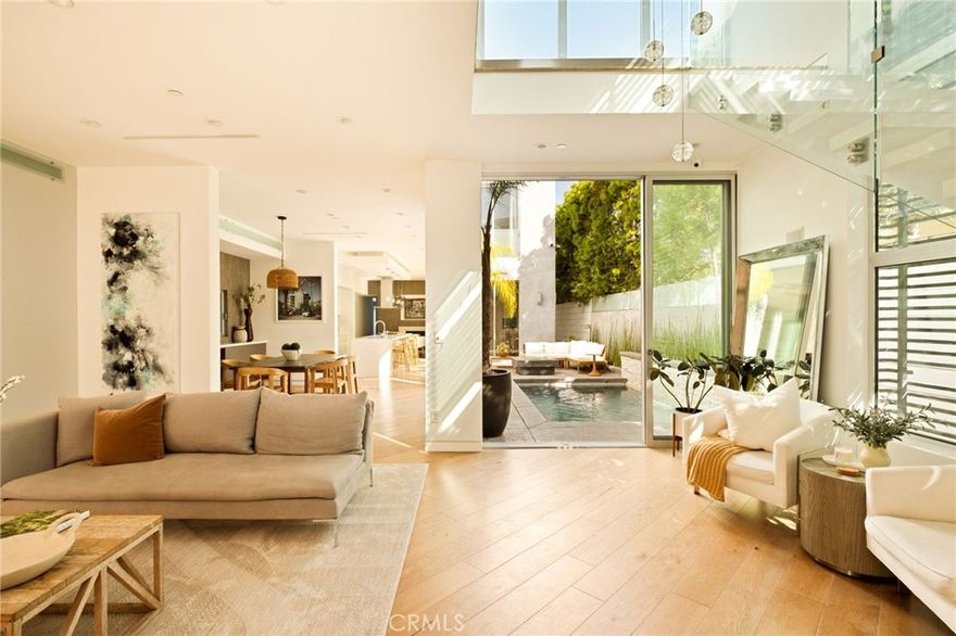 Experience the beauty of Venice Beach living at 936 Milwood — a modern architectural jewel blending sophistication with effortless indoor-outdoor flow. Behind a private gated entry, light-filled interiors open through floor-to-ceiling glass to a sparkling pool, fire pit, and courtyard — creating a true entertainer’s paradise.  



The main level’s open floor plan showcases rich hardwood floors and bespoke finishes, while upstairs offers a serene primary suite with bonus space, an additional bedroom, office, and den.  The third floor consists of a family room that opens into a rooftop deck.  At the back of the house, a separate staircase leads to a private guest unit with attached bath, providing ultimate flexibility.



On one of the best palm tree lined streets in Venice and just moments from Abbot Kinney, boutiques, cafes, and the beach, 936 Milwood is the ultimate expression of modern coastal luxury.