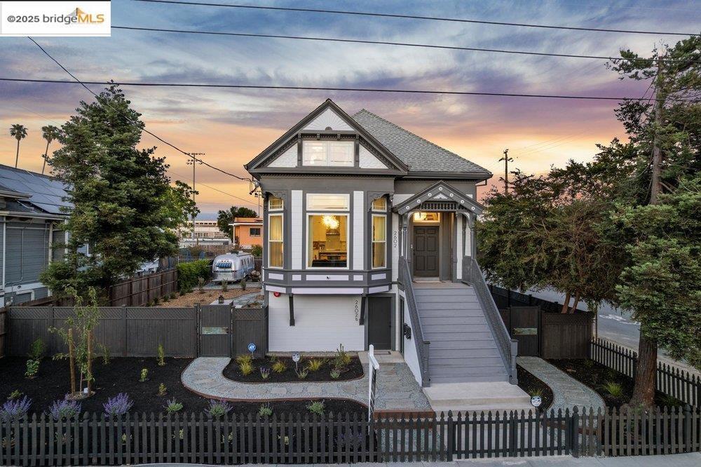 Where Victorian artistry meets modern sustainability, 2602 Adeline Street is a rare West Oakland property with the makings of an extraordinary compound. The main residence, equipped with solar, is a gorgeously reimagined two-story home featuring an open-concept kitchen, dining, and living room, two sunlit bedrooms with soaring ceilings, and 1.5 stylish baths downstairs. Upstairs, two architecturally striking rooms and an additional 1.5 baths include a flexible retreat—fabulous 4th bedroom or lounge—with wet bar, sitting areas, and a balcony with views of the Town and Hills. Outdoors, a parklike yard showcases mature redwoods, garden beds, and multiple sitting areas in West Oakland’s coveted microclimate, ideal for fruit trees and outdoor dining. Beyond the home lies compound potential: a fully restored 1982 Airstream in final stages of permitting as a dwelling, a huge detached garage/workshop with EV charger, and a lower unit with French doors and new foundation—ready for build-out as guest space, studio, or flex-use. A blend of history, design, and versatility, 2602 Adeline is a property like no other.