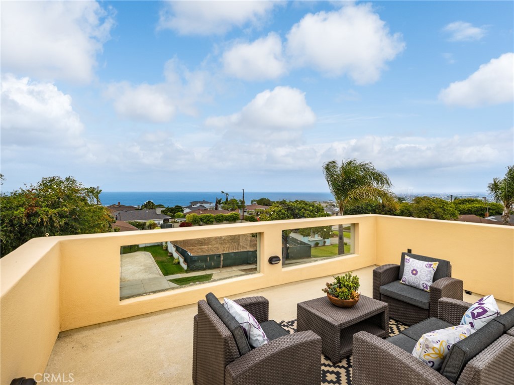 This stunning 3775 sq ft, five bedroom, four bathroom, Mediterranean-style home is nestled in a highly sought-after neighborhood. It offers a blend of traditional Mediterranean aesthetics and contemporary design elements that focus on a creating a spacious, light-filled, and inviting environment where rooms flow seamlessly into each other. As you enter, you will find a large foyer leading to a large open living area/family room with wet bar, three bedrooms, two bathrooms, and a laundry room. Upstairs, you'll discover a sun drenched, open floor plan including a living room, dining room, kitchen with warm wood cabinets, granite counters and eating area, two en-suite bedrooms including an expansive primary suite with an over-sized walk-in closet. The thoughtful layout allows each floor to function as its own living space. Additional features include: beautifully landscaped outdoor living space that is ideal for entertaining or relaxing, ample storage and closet space throughout, a convenient location close to the beach, schools, parks, shopping, and dining. This gorgeous home offers the perfect combination of style, functionality, and location making it an exceptional choice for multi-generational living, families, professionals, singles that want space or enjoy entertaining, or anyone looking for coastal living at its finest.