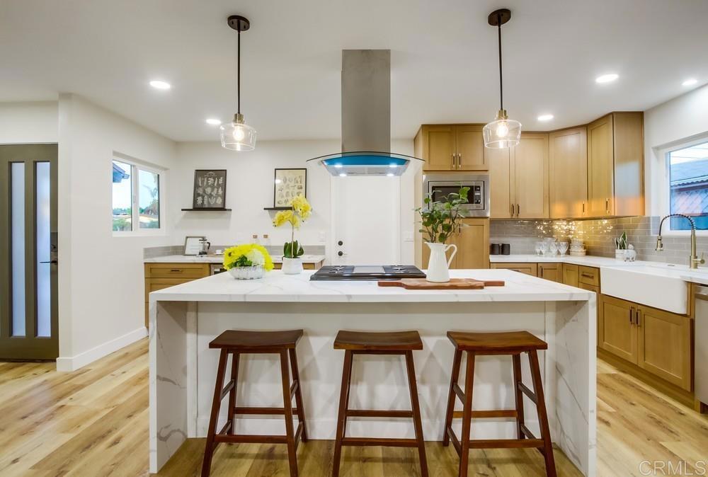 Great location! Just one block from Convoy Street, this fully remodeled home puts you in the heart of San Diego’s premier dining district, with easy access to Interstates 805, 163, 52, and 15. Whether you’re commuting or heading out for amazing food, this central spot makes everything convenient. Inside, you’ll find an open-concept layout with all stainless steel appliances, including a double-door refrigerator and built-in microwave. The kitchen shines with a waterfall-edge island, quartz counters, extra storage, and modern finishes throughout. The bathrooms are beautifully updated with tiled shower walls, new vanities, and stylish fixtures. Each bedroom offers a ceiling fan and its own mini-split system, with an additional unit in the main living area—delivering efficient, customizable comfort. A true bonus is the additional versatile room, ideal as a home office, game room, fitness space, or creative studio—adding flexibility to fit your lifestyle. Major upgrades include a new 200-amp electrical panel and ABS main sewer line for peace of mind. Outside, enjoy a drought-resistant landscape with artificial turf, decorative gravel, and woodchip accents—designed for beauty and low maintenance. This home is completely move-in ready and located in one of San Diego’s most convenient, sought-after areas. Schedule your private showing today!