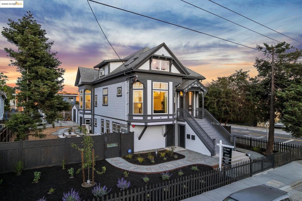 Meticulously renovated Queen Anne Victorian blends historic charm with modern luxury in this spacious 3+ bedroom, 2 full bathroom, 2 1/2 bath West Oakland duplex. Period details; fish scale shingles, turned porch posts, + sunburst pediments, meet contemporary upgrades; Bosch appliances, Carrara marble countertops, Heath tile, engineered wood floors, skylights, & heat pump/mini splits throughout. Enter to a grand foyer, w/open plan chef’s kitchen, dining, living room and luxurious 1/2 bath. Two sunny, generous bedrooms, laundry area, and a spa-like bathroom grace the main level of the home as well. Upper level features two expansive living/lounge areas, stylish wet bar, private balcony, chic 1/2 bath w/adjacent office (or convert to full bath), + closet. Down the hall find the serene spa-inspired bathroom & stunning vaulted-ceiling primary suite w/ skylights & large walk-in closet. Ground level unit, ready for build-out, offers seamless indoor-outdoor flow to landscaped yard w/raised garden beds, irrigation, custom cedar/redwood fencing, + ample parking. Bonus: fully renovated 1982 Airstream Excella w/custom finishes—ideal for guest space, studio, or rental. A rare blend of character, comfort, and elevated design!