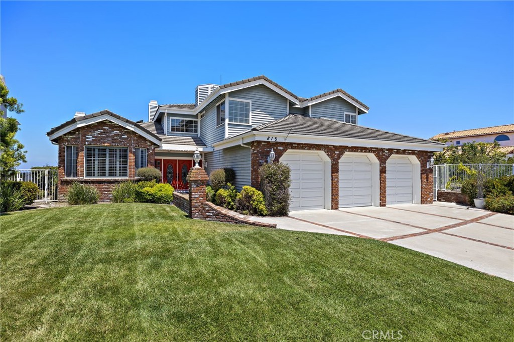 Located at one of the highest points in San Clemente, this impressive Misty Ridge home represents an outstanding value-oriented opportunity to enjoy life at the top. A desirable cul-de-sac setting reveals an enormous elevated homesite that spans approximately 28,000 square feet and embraces a peek at the ocean and panoramic canyon, hill, city-light and Saddleback Mountain views. Beautiful hardscaping and a large front lawn harmonize with traditionally styled architecture, and custom entry doors with leaded-glass windows and sidelites create a memorable first impression. Generous proportions continue indoors, where a sprawling two-level floorplan of approximately 3,839 square feet feels even larger with high ceilings and vast window expanses. A graceful circular staircase captures eye in a foyer with double-height ceiling that leads to an office with bay window and built-in desk, and a formal living room with elegant fireplace and French doors opening to a shaded rear patio. To the right of the entry awaits a formal dining room with ample room for grand-scale entertaining. Views embellish the casual family room, which is warmed by a brick fireplace with raised hearth and hosts a pub-style walk-in wet bar. Views continue in the kitchen, complete with a nook with bay window, an island, wood cabinetry, solid-surface countertops, garden window and stainless-steel appliances. Five bedrooms and four- and one-half baths include a convenient main-floor bedroom with ensuite bath, two that share a bath upstairs, and a second-floor ensuite with walk-in closet. Double doors open to the stunning primary suite, which presents a large view-enhanced sitting area with fireplace, two walk-in closets, two sinks, a sit-down vanity, jetted tub, and a separate shower with skylight. Wood and tile flooring, plantation shutters, mirrored wardrobe doors, tray ceilings, crown molding, an interior laundry room with sink, a rooftop deck area and an attached three-car garage with built-in storage are featured. For the ultimate in SoCal living, simply step into the backyard, where a large pool and spa, expansive patio, built-in BBQ bar and magnificent views are on display. Extending nearly 26,959 square feet, the massive lot next door is also available for sale and can be purchased separately or in combination with this property. It offers equally impressive views and virtually endless possibilities. Beaches, San Clemente’s pier, top schools and recreation are minutes from home.